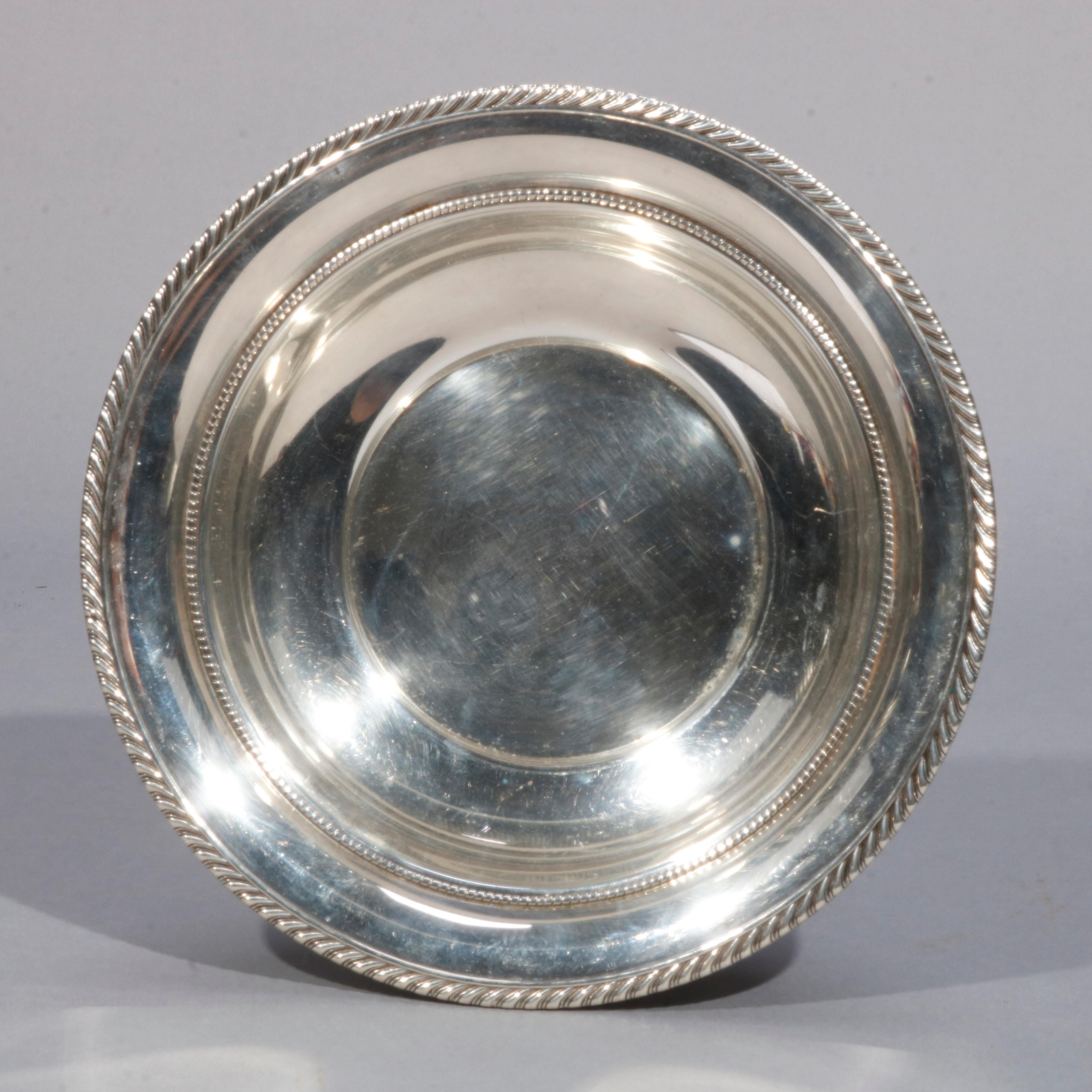 An antique serving bowl by Gorham offers sterling silver construction with gadrooned edge, maker marked on base as photographed, 8.3 toz, 20th century

Measures: 2