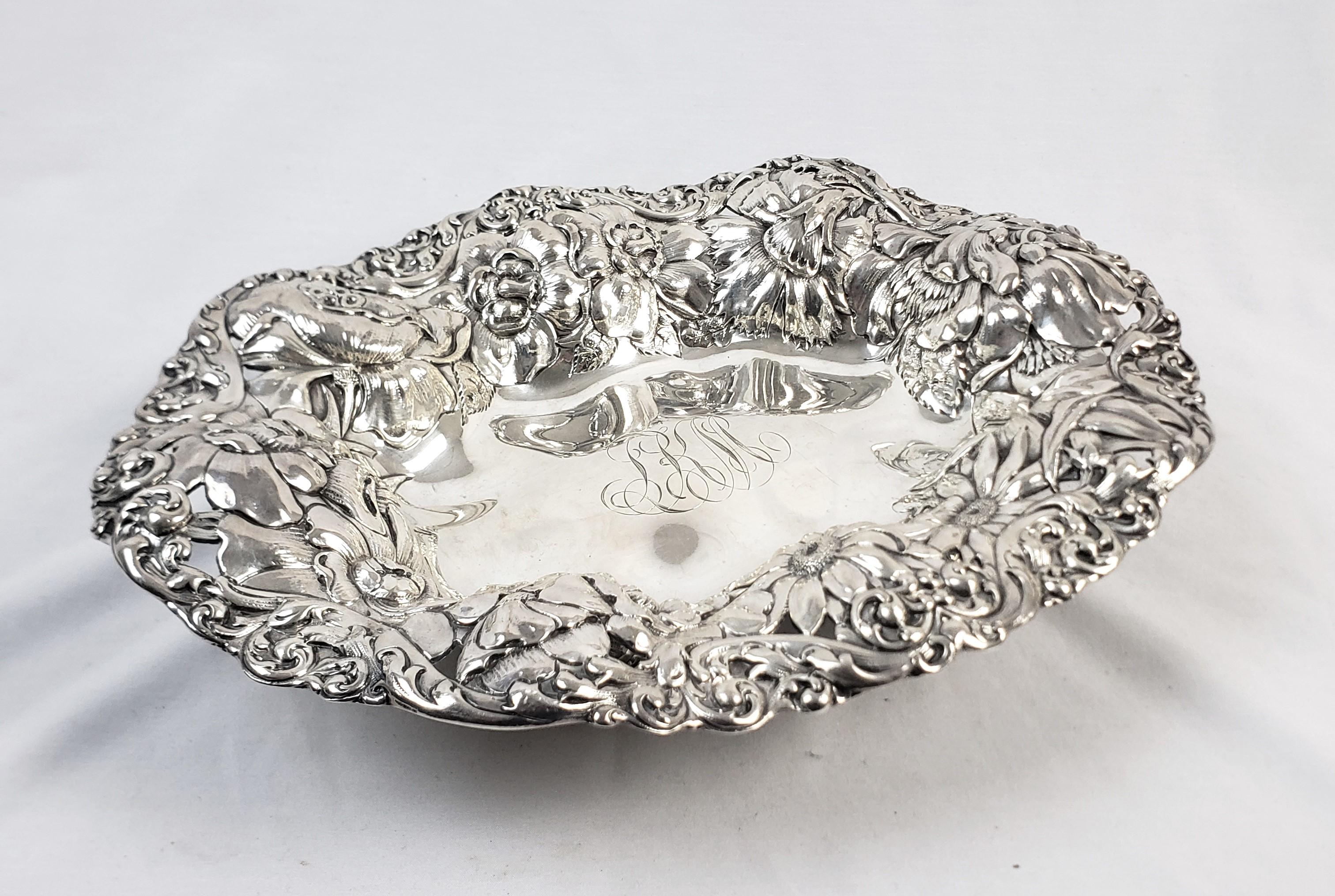 This antique bowl was made by the renowed Gorham Company of the United States and dates to approximately 1900 and done in a Victorian style. The bowl is composed of sterling silver and features an ornately pierced and chased floral rim. The bowl is