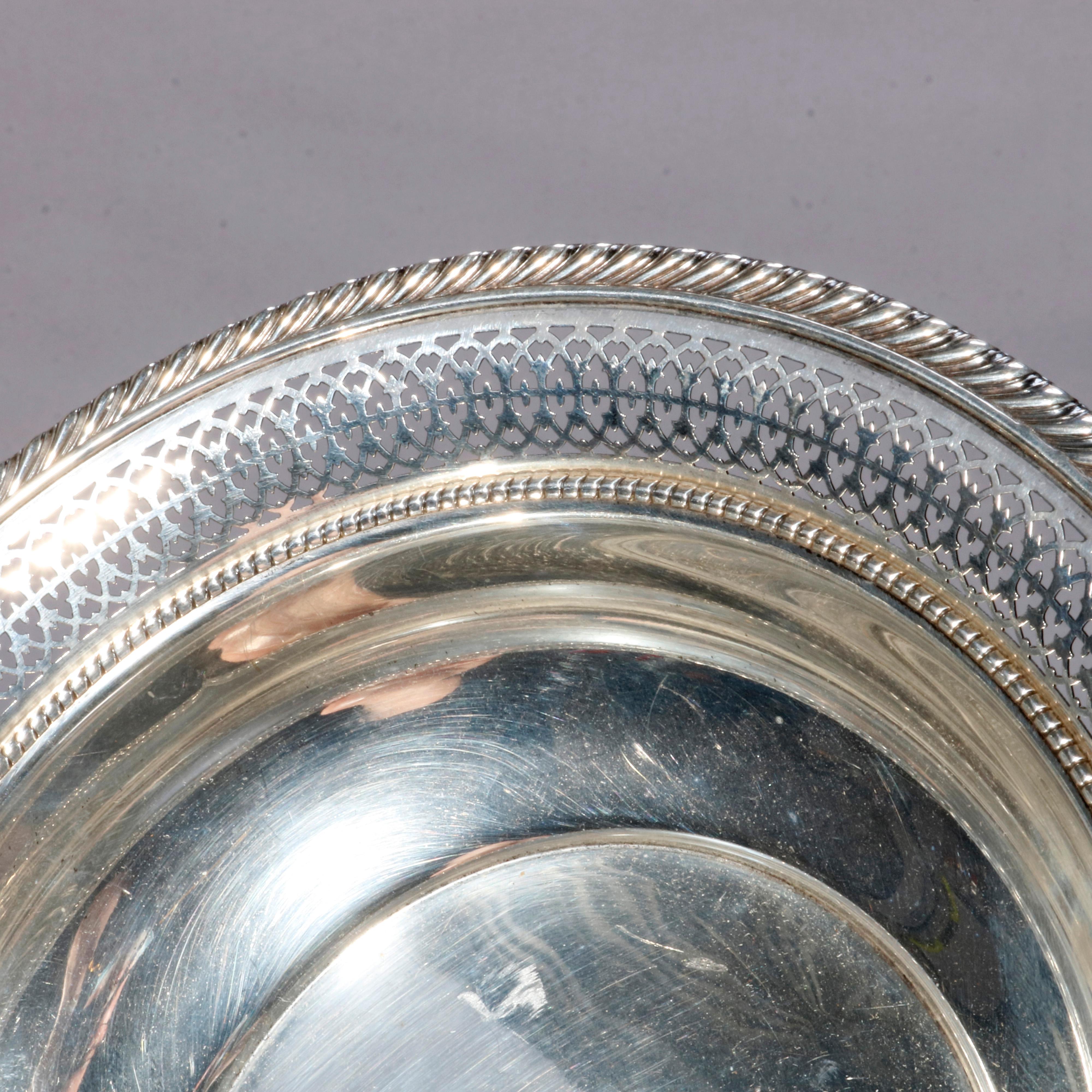 An antique sterling silver serving bowl by Gorham offers rope twist and reticulated rim with central monogram as photographed, marked on base as photographed, 6.9 toz, 20th century.

Measures: 2
