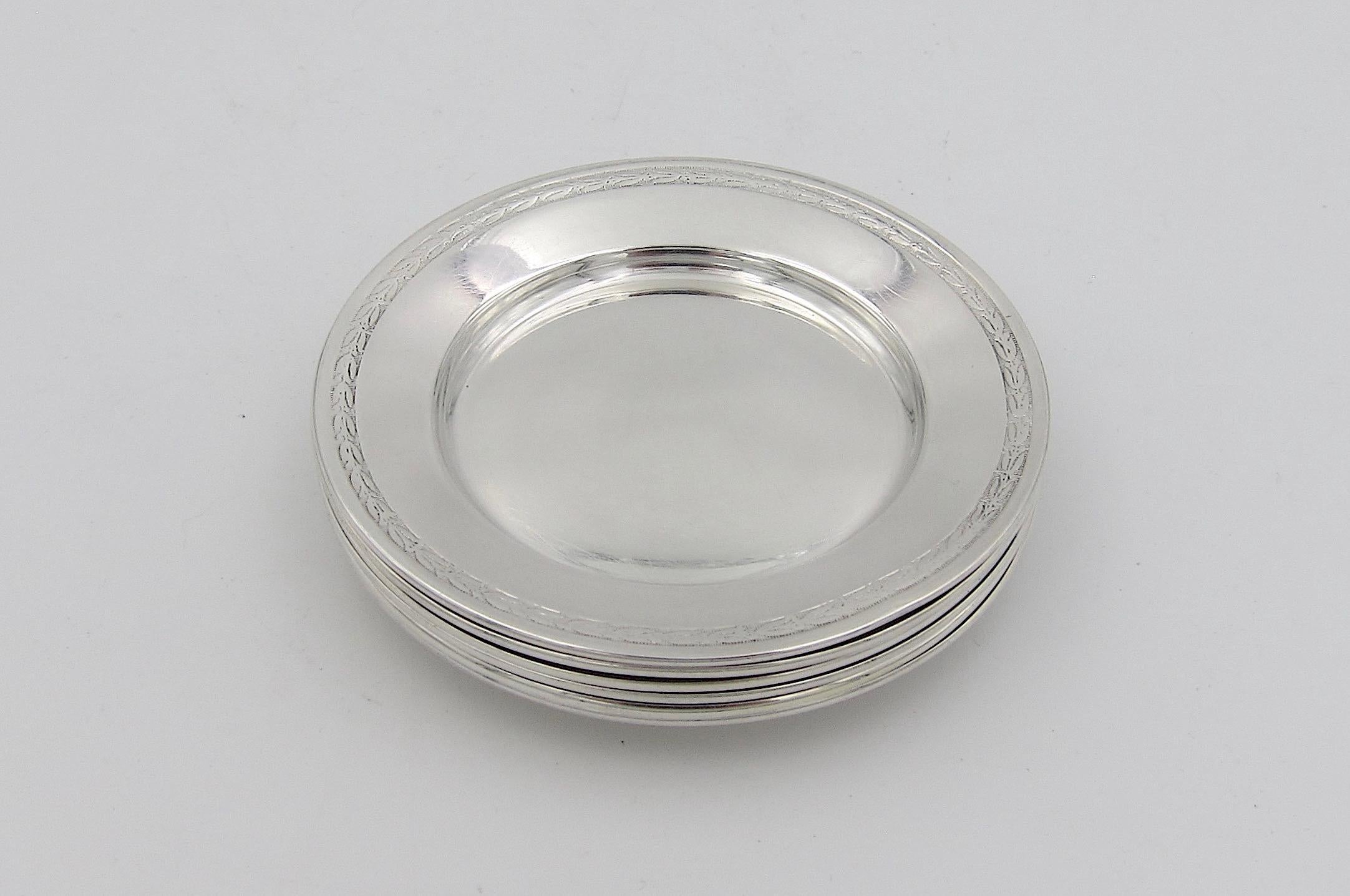 An antique matching set of six round, individual butter pats in sterling silver from Gorham Manufacturing Company of Providence, Rhode Island. Decorated with an elegant engraved band encircling each rim with an 1872 date mark underfoot. No