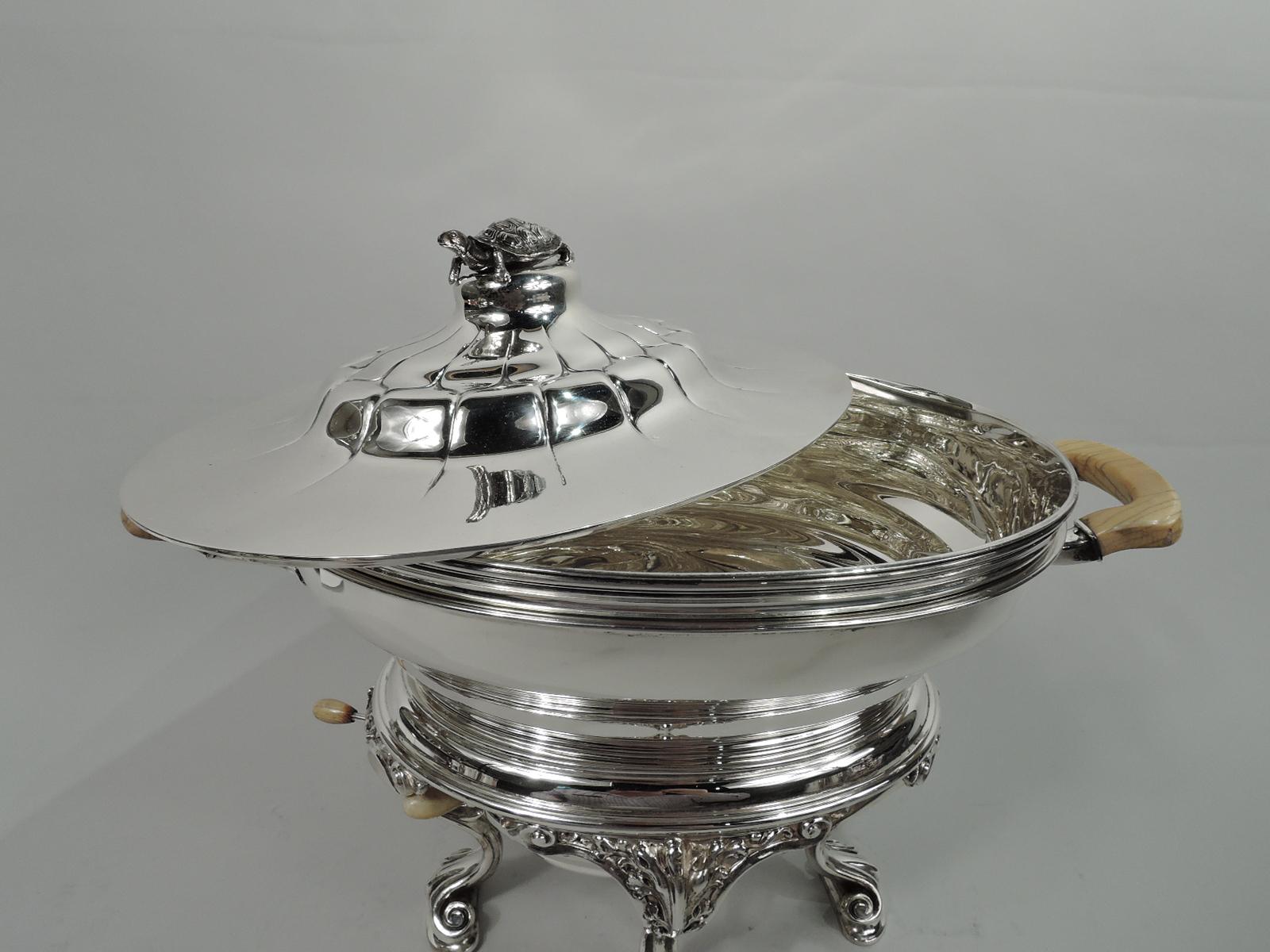 Edwardian sterling silver chafing dish. Made by Gorham in Providence in 1903. Oval bombe bowl with leaf-mounted bracket handles. Liner has reeded rim. Cover double-domed with tooled shell pattern and cast turtle finial with overhanging legs,