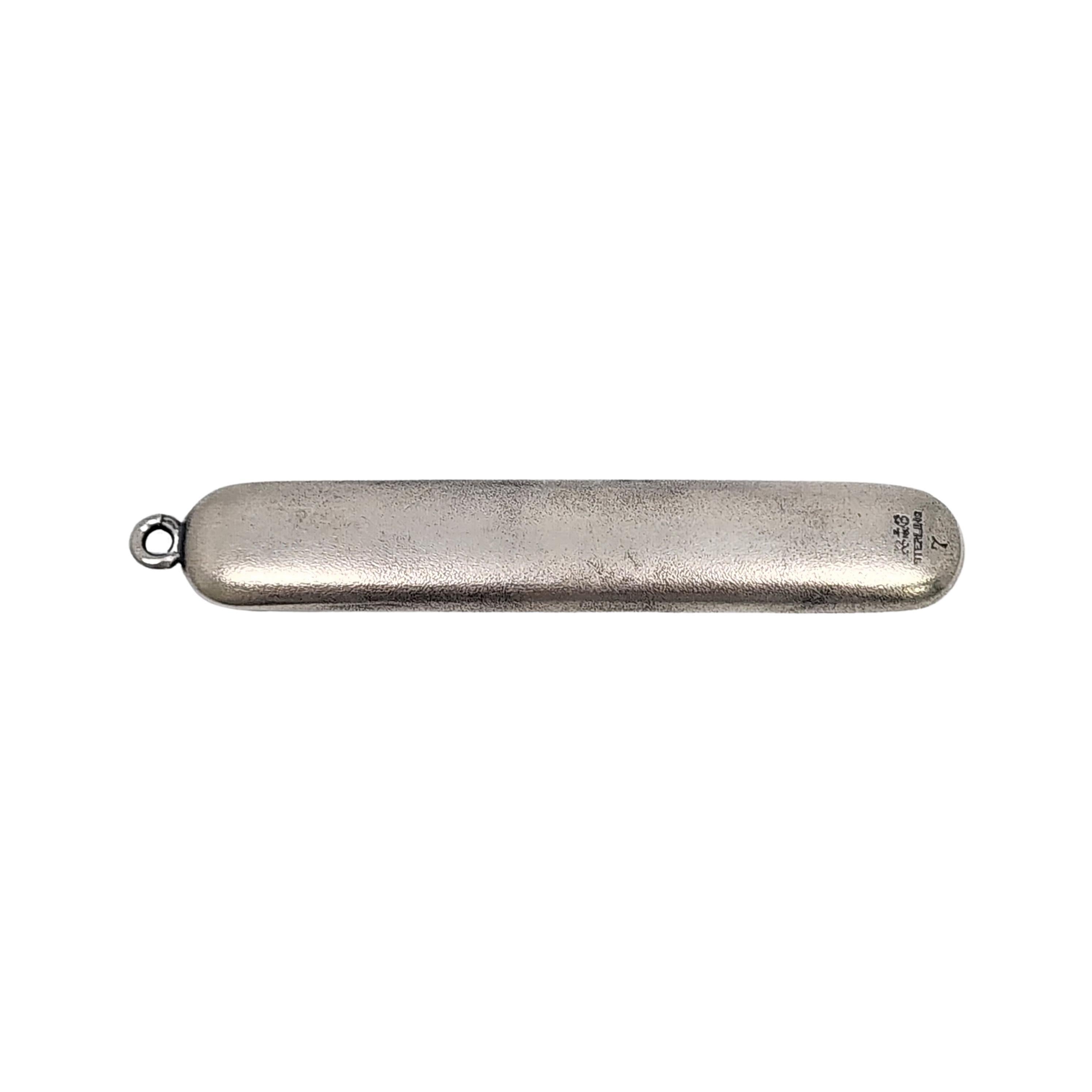 Antique sterling silver chatelaine sewing needle case by Gorham.

Monogram appears to be MCN.

A simple sewing case with a rounded square opening and small round loop to wear on a chatelaine or chain. Monogram is engraved on one side.

Measures