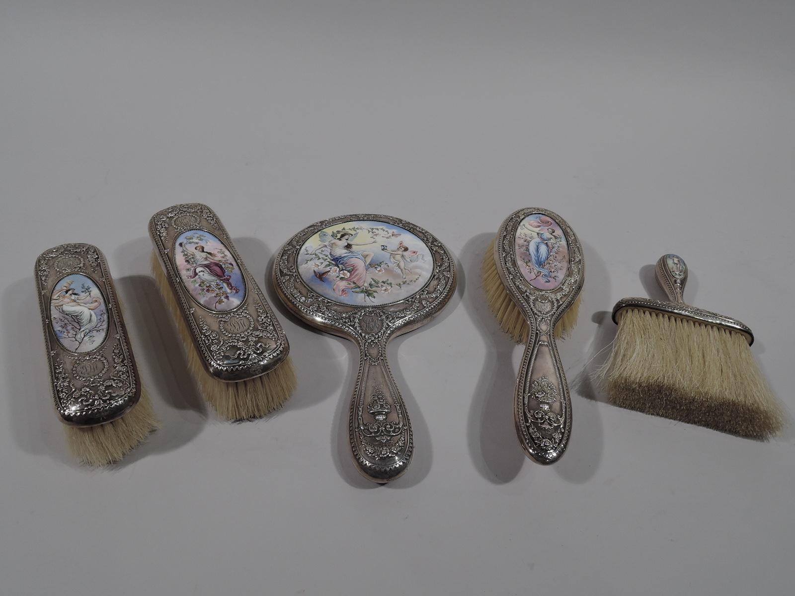 Classical sterling silver and enamel vanity set. Made by Gorham in Providence in 1900. This set comprises 7 pieces (dimensions in inches): Round and beveled hand mirror (H 9 3/4); hairbrush (H 9); clothing brush (L 6 7/8), clothing brush (L 6),