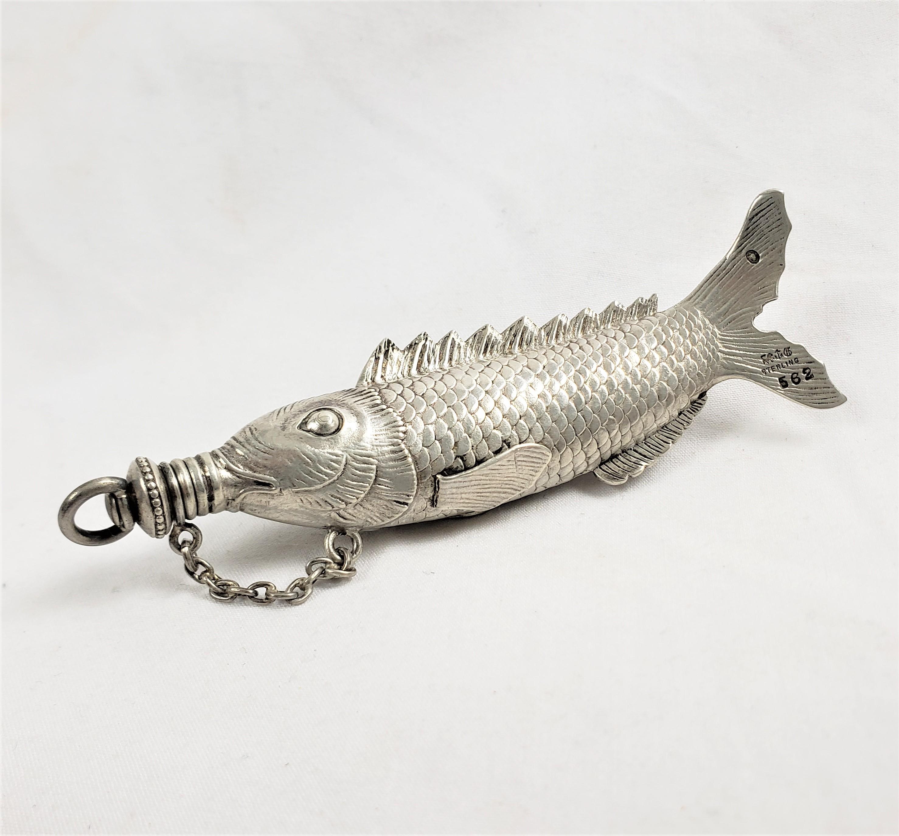 This antique perfume or scent bottle was made by the well known Gorham Co. of the United States in approximately 1880 in the period Victorian style. The bottle is composed of sterling silver and is an ornately made figural fish with a threaded