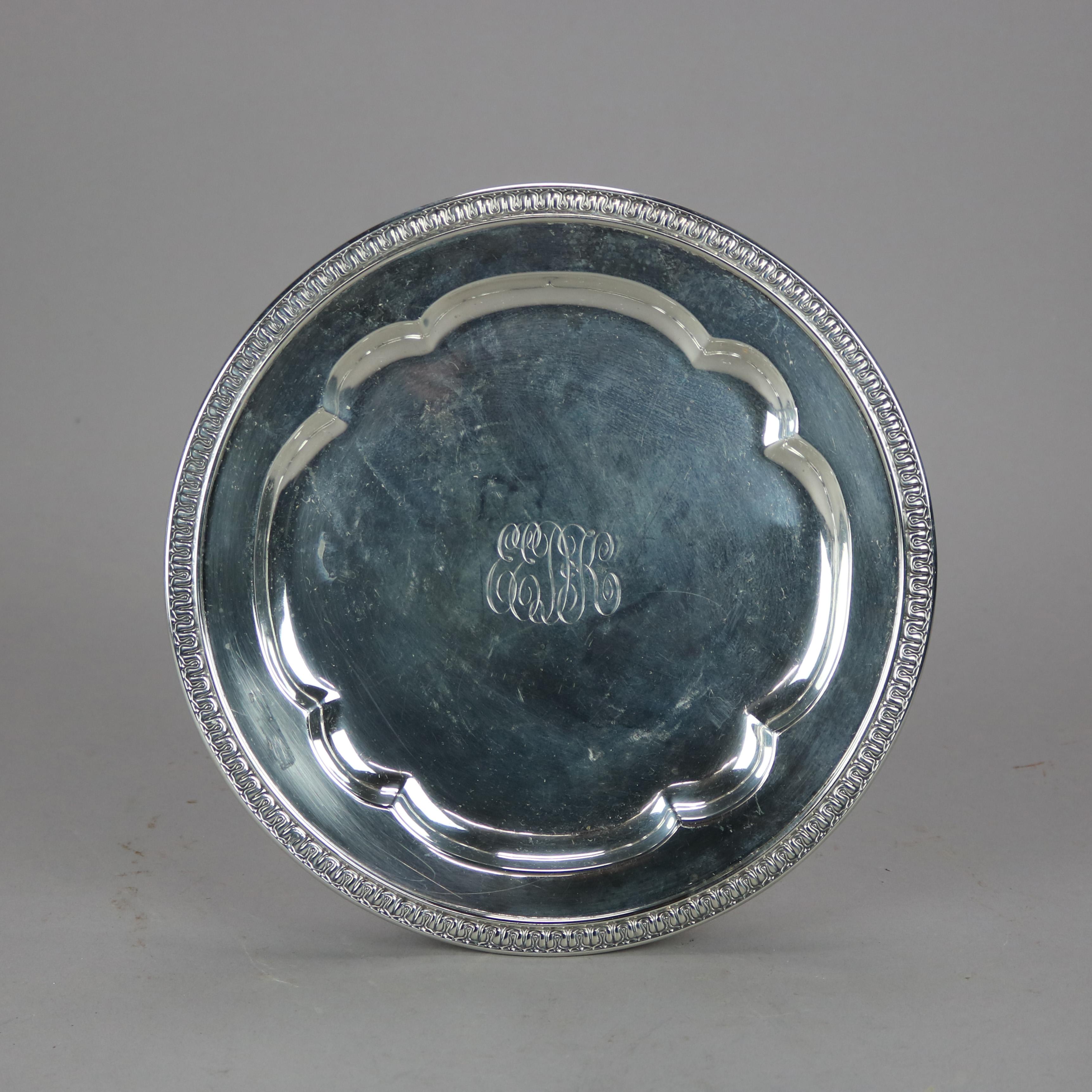 An antique Gorham tray offers sterling silver construction with rim having decorative trim, shaped well with monogram, maker stamps en verso as photographed, 17.43 toz, dated 1899

Measures - .5''H x 10''W x 10''D.