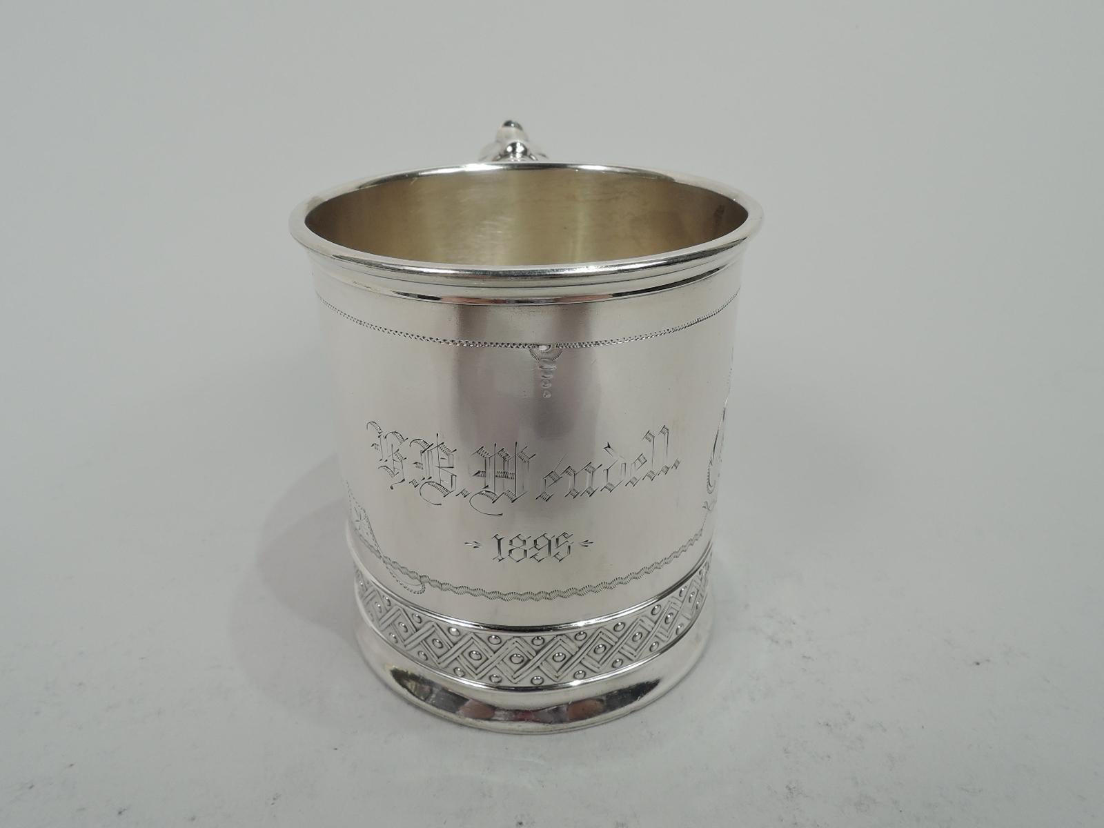 Victorian Aesthetic sterling silver christening mug. Made by Gorham in Providence in 1894. Straight sides with gently curved base. Curvilinear frame with zigzag and wavy borders between clusters of dramatic leafing scrollwork and flowers. Engraved