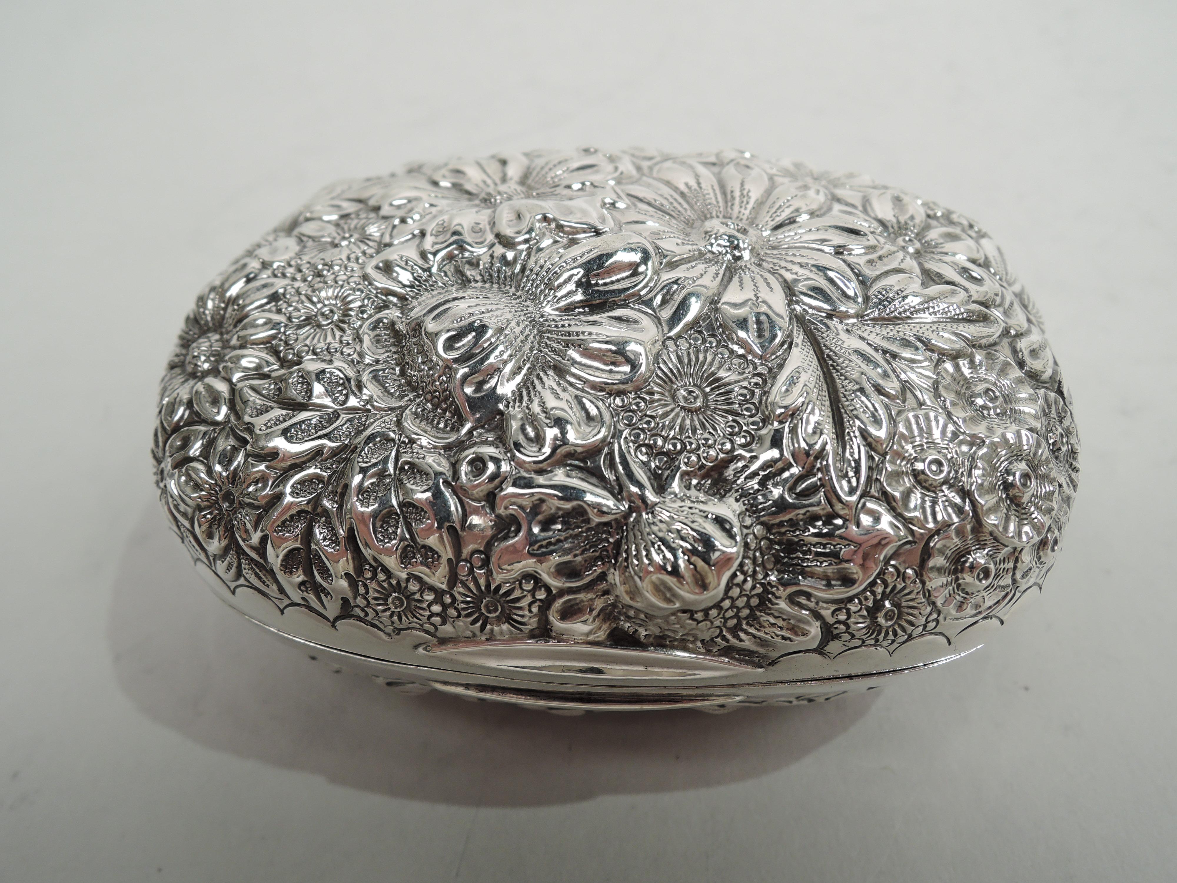 Victorian sterling silver soap box. Made by Gorham in Providence in 1896. Hinged and rectangular with curved corners. Allover floral repousse. Plain scalloped borders and lunette tabs. Cover top has asymmetrical scrolled cartouche (vacant). Fully