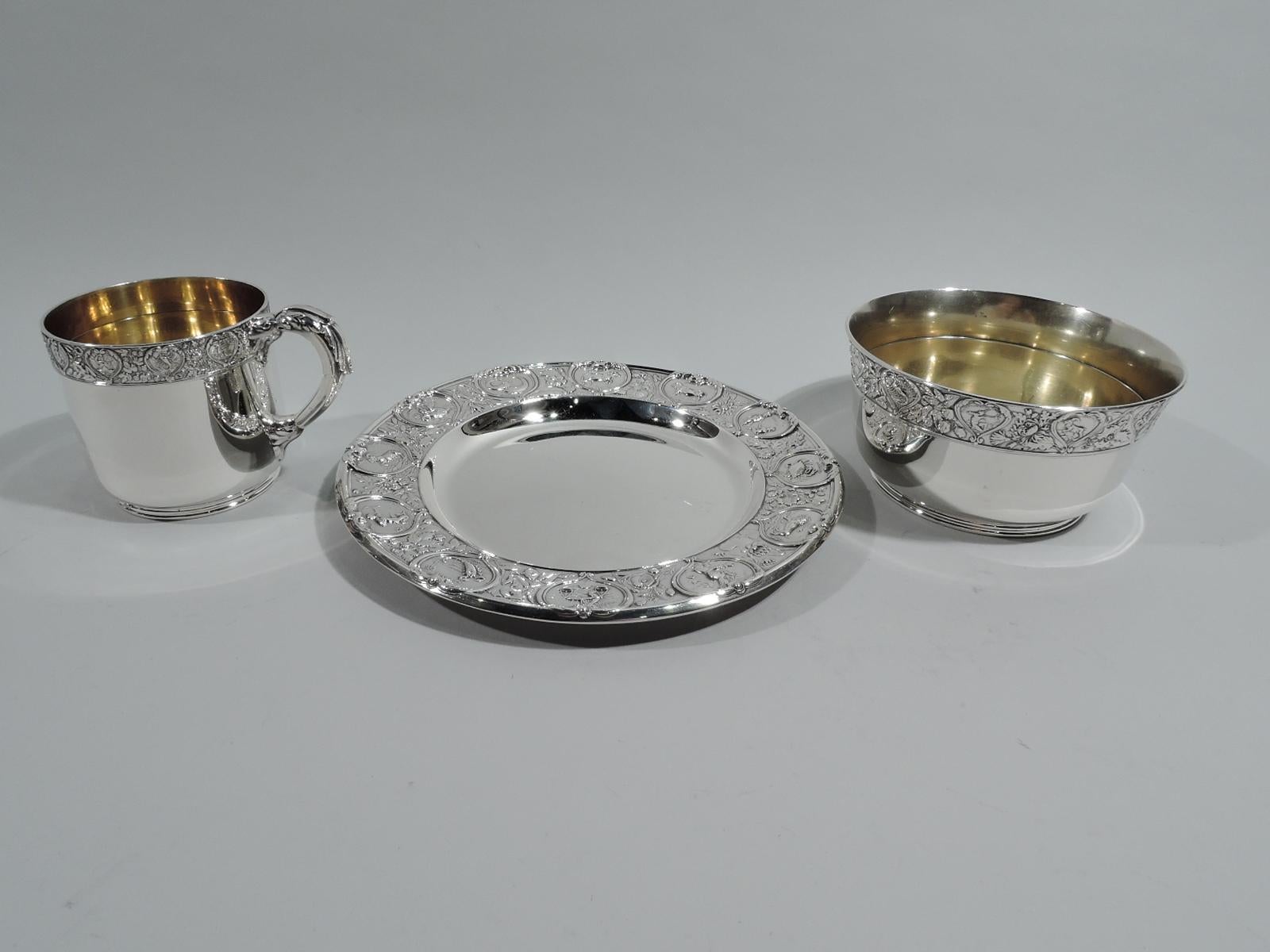 Zodiac sterling silver 3-piece baby set. Made by Gorham in Providence in 1915. This set comprises mug, bowl, and plate. Cup: Straight sides, short inset foot, and leaf-capped and mounted handle; interior gilt washed. Bowl: Gently tapering sides,