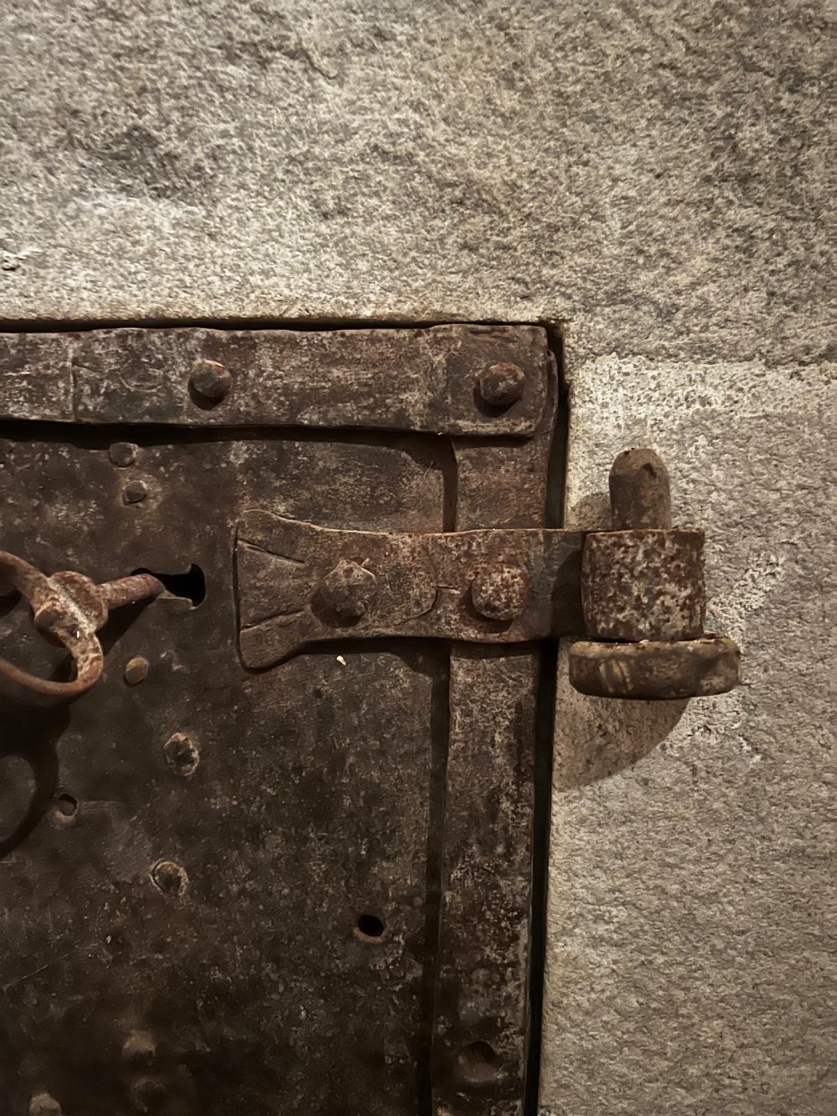 An exceptional and rare 16th century Gothic wrought iron safe door, featuring an advanced three-key multipoint locking system, a testament to the high craftsmanship and security innovations of its time. Such doors were commonly found in castles,