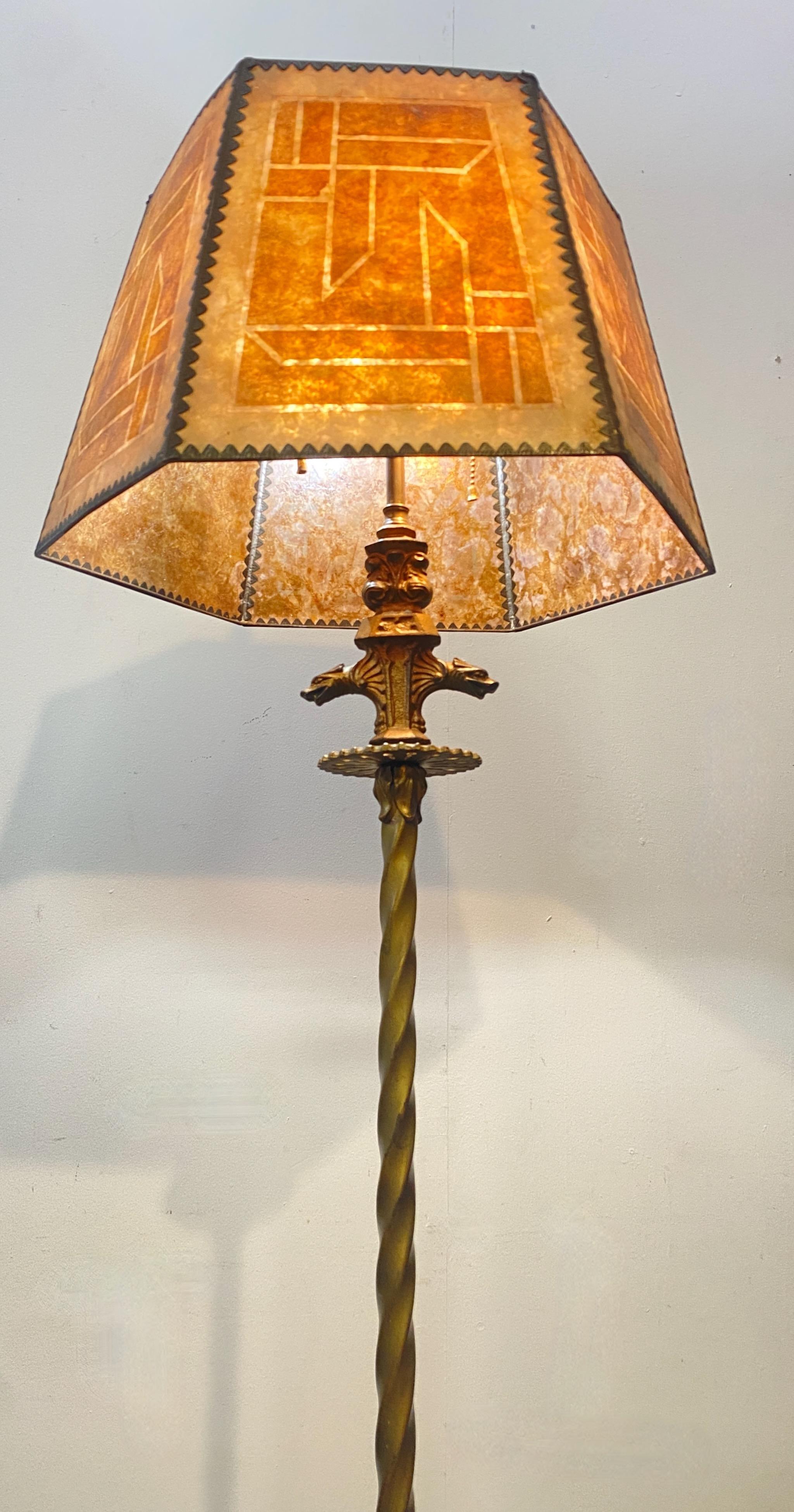 Art Deco period Iron and brass floor with mica shade. 
Excellent quality lamp base with wonderful mica shade having brass framing all the individual panels. 
Recently re-wired.
Diameter of the shade is 18 inches.
American, early 20th century.