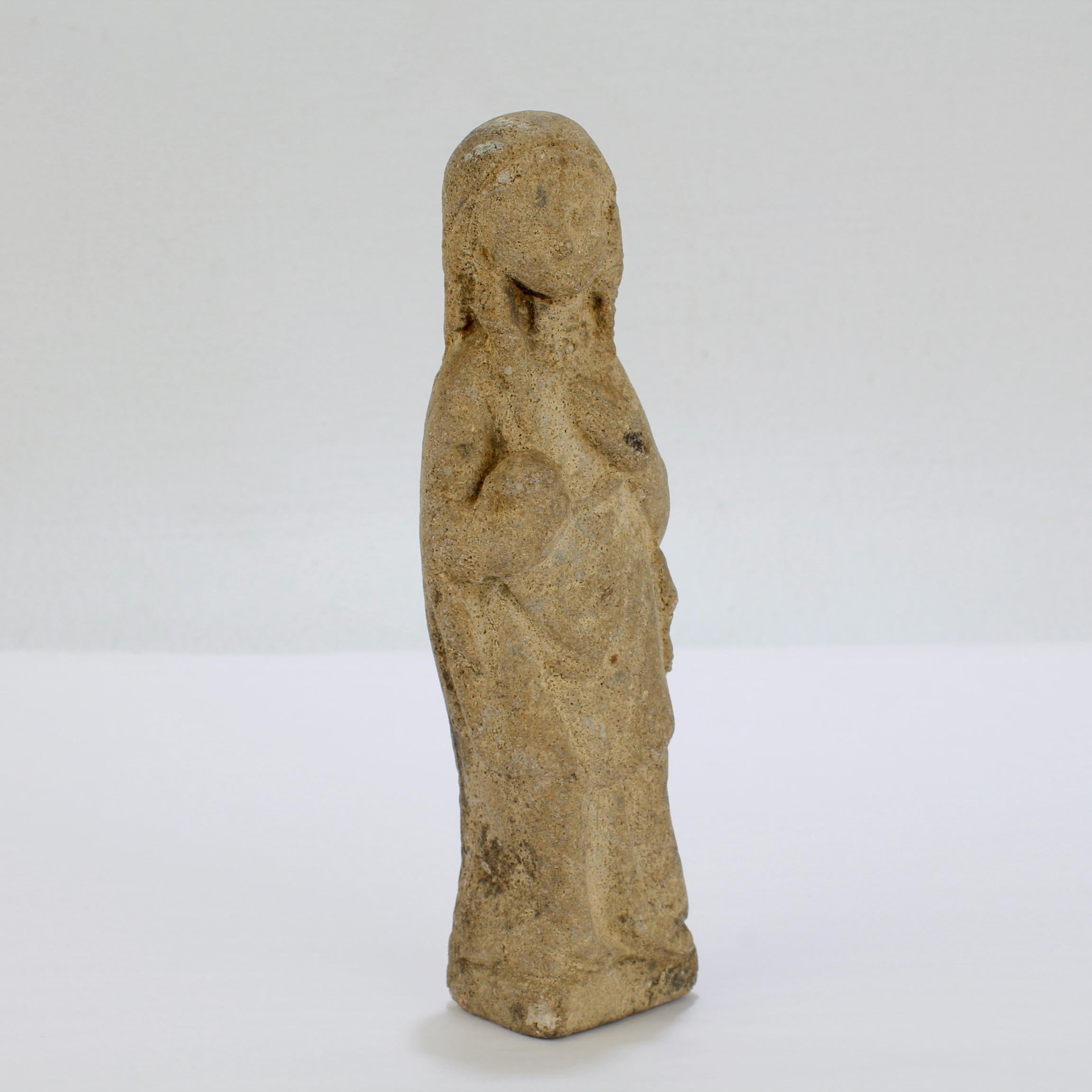 A fine antique limestone carving.

Modeled as a Madonna.

With her head slightly tilted, holding an orb in one hand, and with her other hand resting on her breast. 

By repute from the collection of William Kelly Simpson.

Simply a wonderful