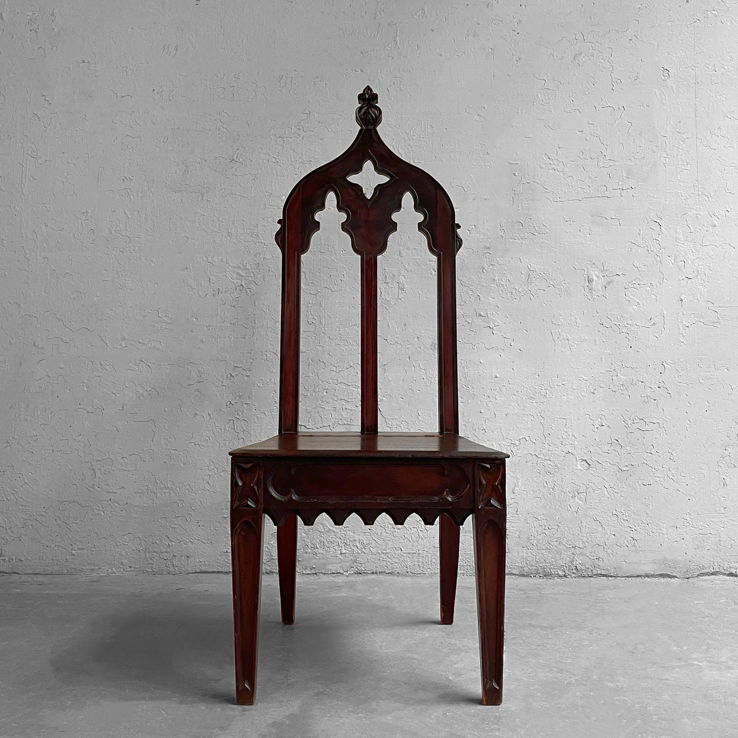 Gothic, carved mahogany church/rectory/prayer chair features a peaked high back with a storage compartment under the seat. Impressive entryway or accent chair.