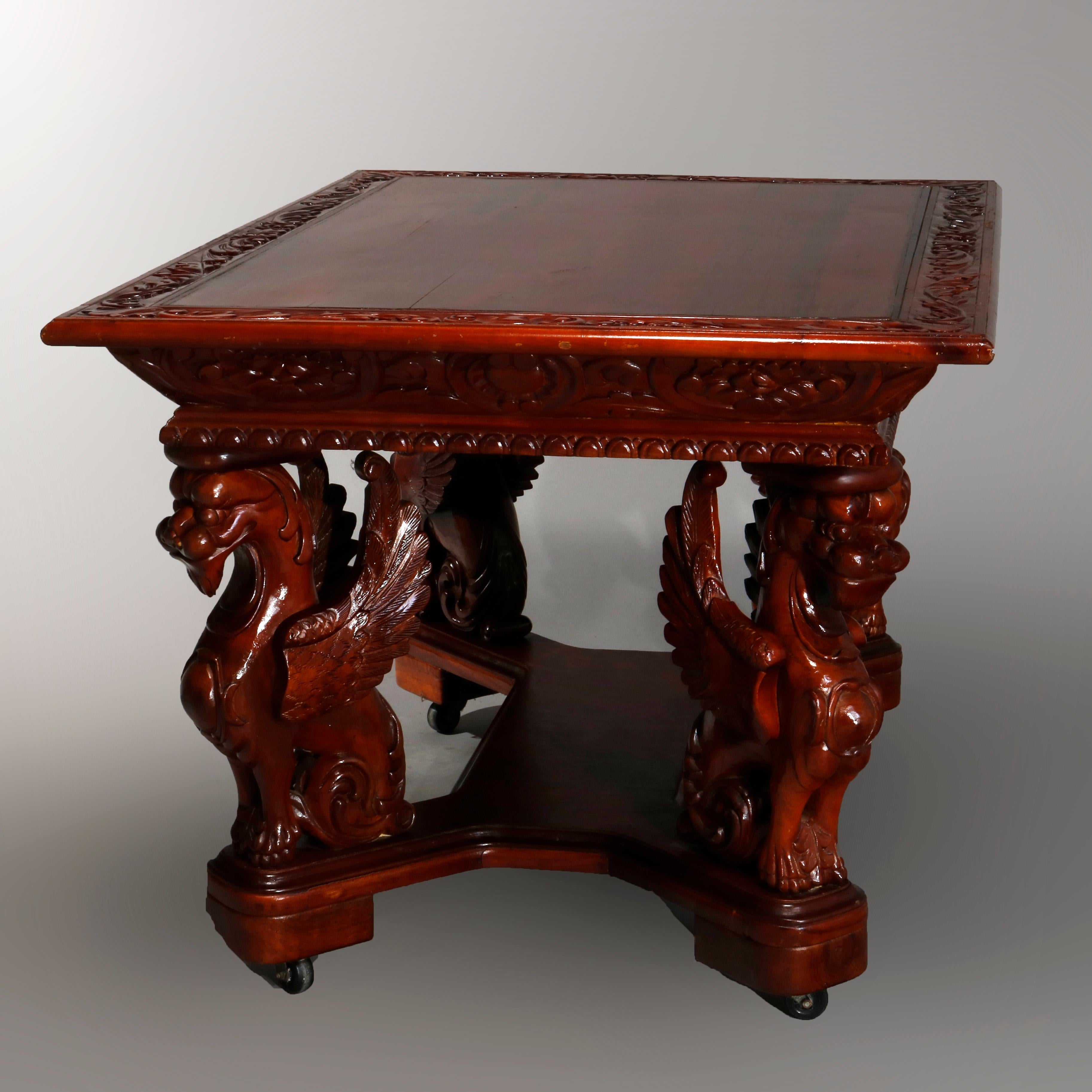 An antique Gothic figural library table offers mahogany construction with top having carved foliate bordering, deep skirt and raised on full sculptural griffin form legs with shaped lower shelf, 20th century


Measures: 31.75