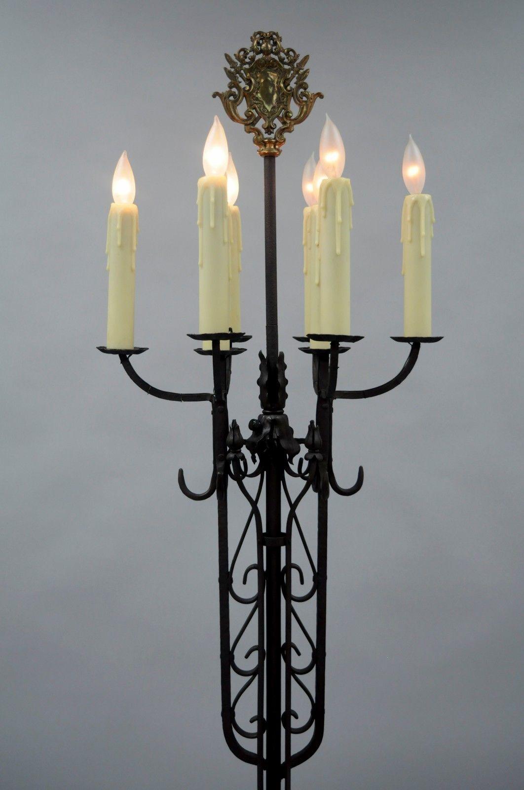 Antique Gothic iron candelabra floor lamp. Item features Heavy iron frame, Seven lights, brass shield finial, Dimmer switch, six hooks which are believed to be for coats, Brown finish (images make the item look black but it is actually brown), Great