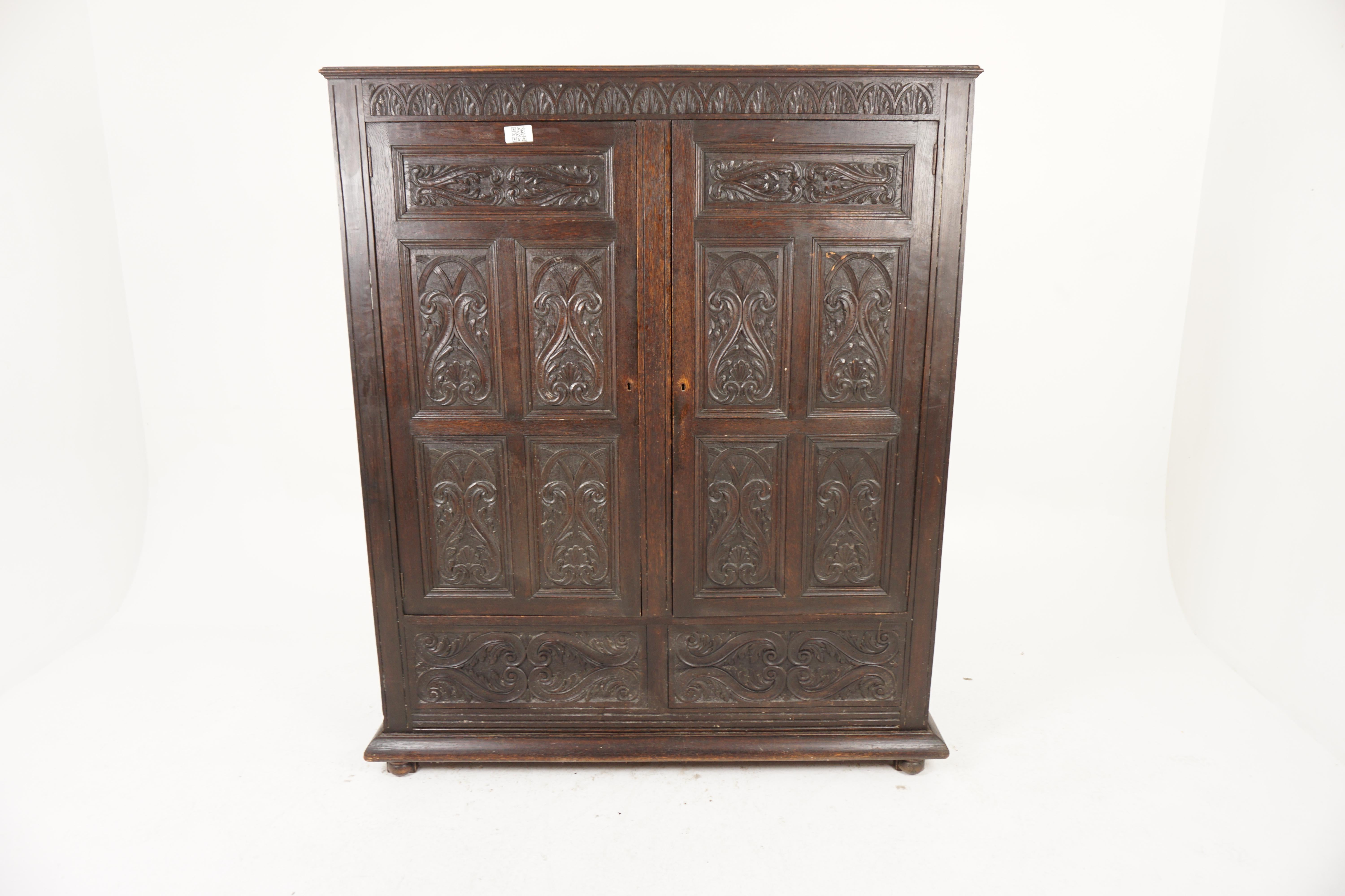 Antique Gothic Oak Housekeeper Cupboard, Hall, Armoire, Scotland 1880, H985

Scotland 1880
Sold oak
Original finish
Carved top with a pair of carved panelled doors underneath
Four panels on each side
The interior has brass hooks and a mirror