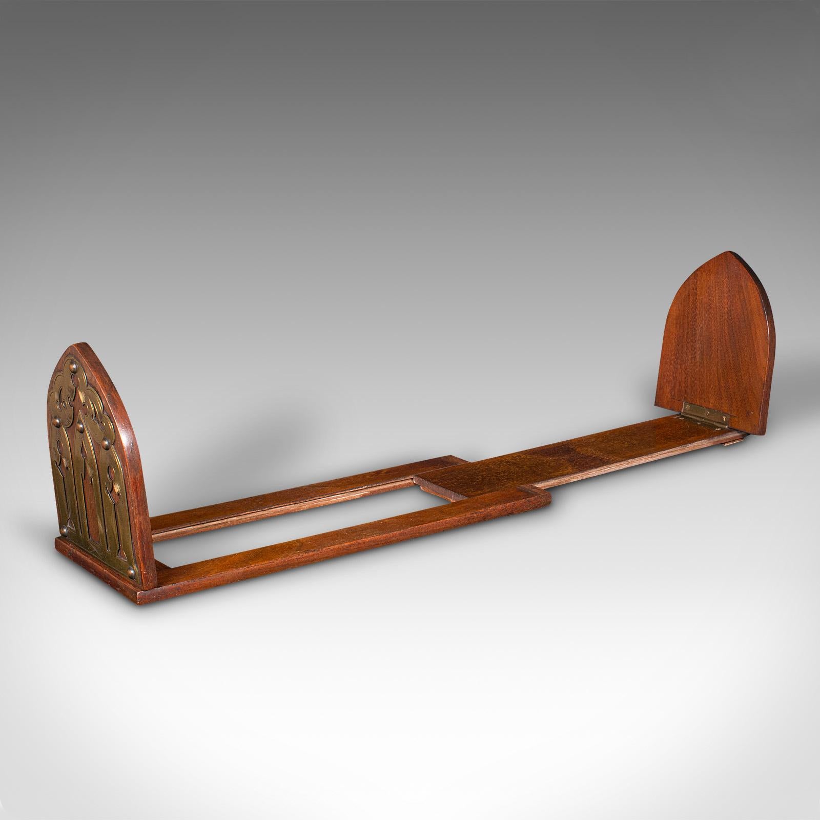 
This is an antique Gothic revival book slide. An English, walnut and brass extending bookrest, dating to the late Victorian period, circa 1880.

Accentuate your reading corner or desk with this charming slide
Displays a desirable aged patina and in