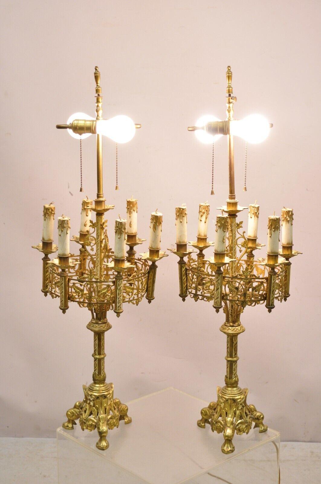 Antique Gothic Revival Gold Bronze Figural Candelabra Table Lamps - a Pair. Item features wooden decorative candles, twin light sockets, pierced decorated frames, very nice antique pair, quality craftsmanship, great style and form. circa Early 20th