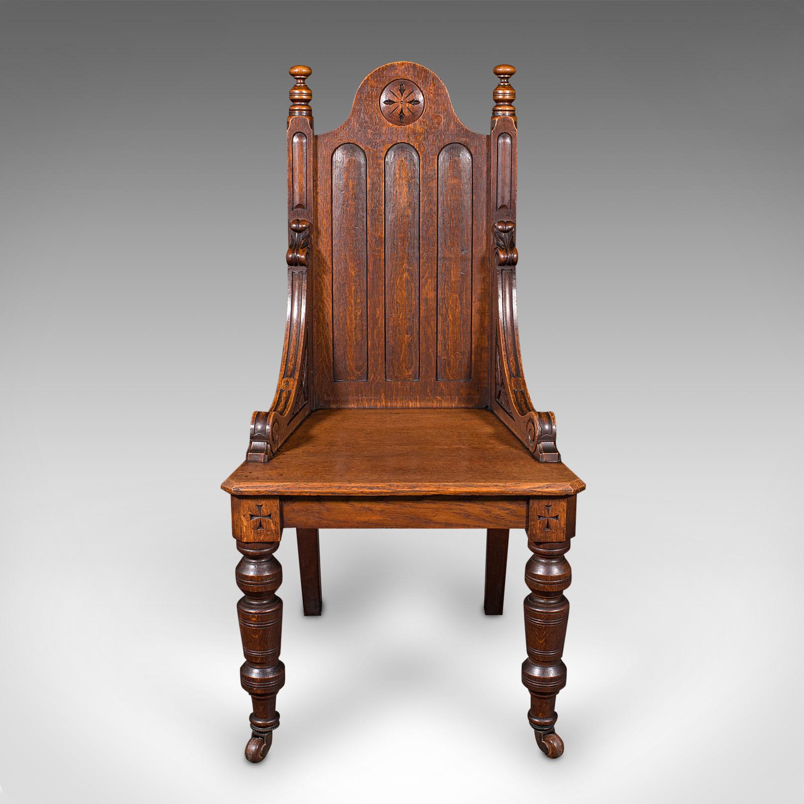 This is an antique Gothic Revival hall chair. A Scottish, oak baronial reception seat, dating to the Victorian period, circa 1870.

Of superb Gothic appearance and excellent proportion
Displays a desirable aged patina and in good order
Select oak