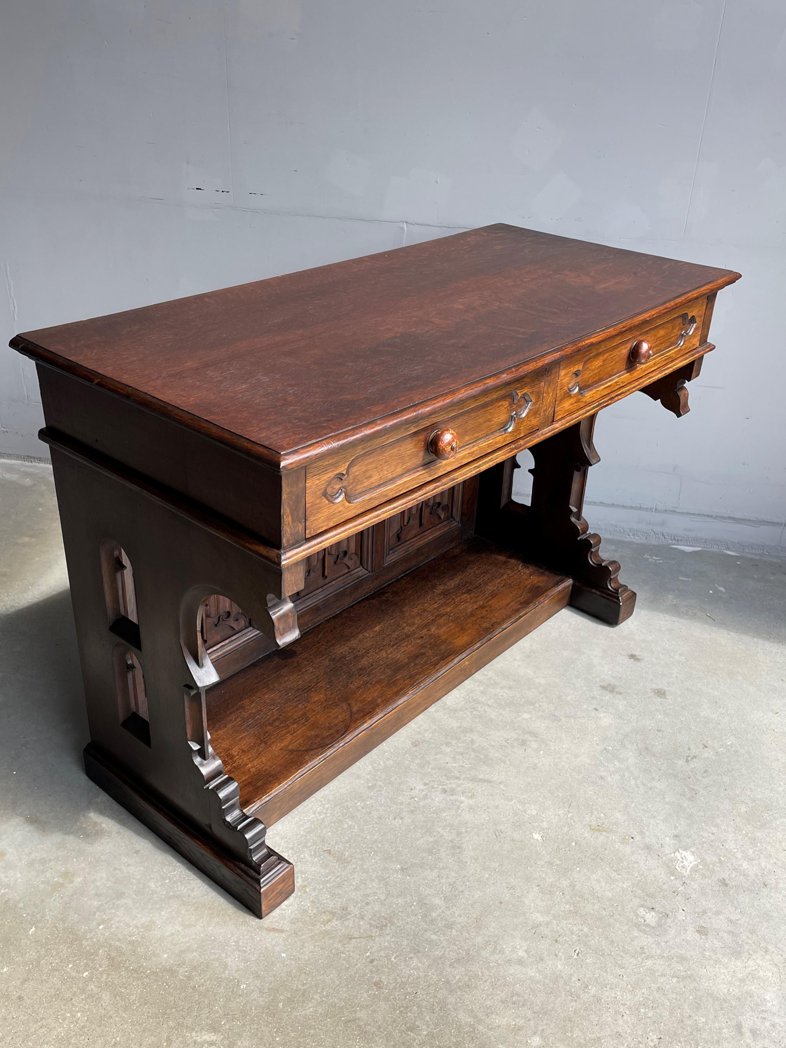 Beautiful and practical size, hand carved Gothic sidetable or small desk.

This rare antique table in the Gothic Style can be placed tight on your wall and thanks to its practical design this Medieval Style beauty can be placed almost anywhere