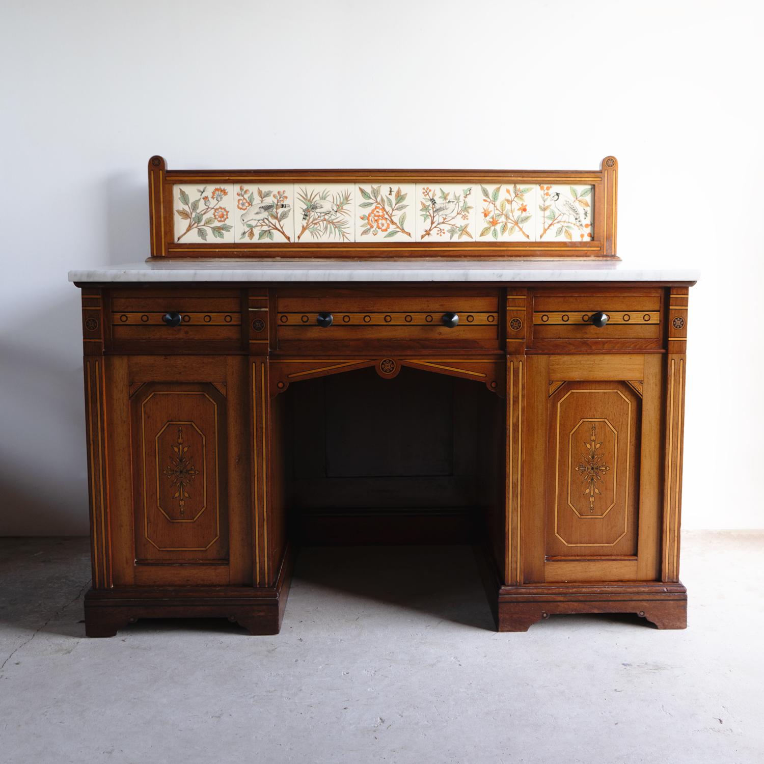 ANTIQUE WASH STAND

A hugely decorative and good-quality washstand on a larger-than-average scale with three drawers over two pedestals containing cupboards, a Carrara marble top and a tiled back.

Made from a mixture of different woods and inlaid