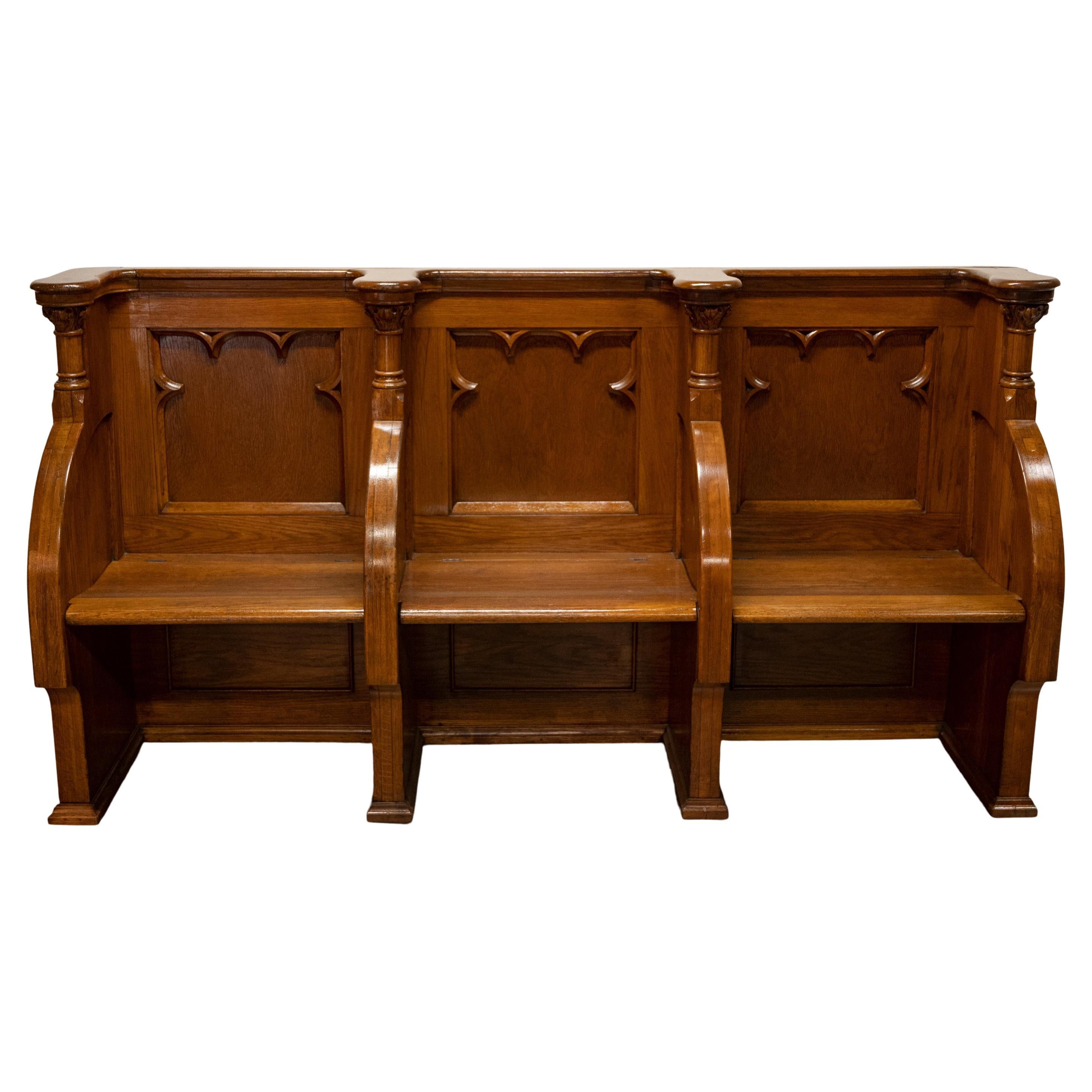 A good & substantial, antique carved oak three seat Gothic Revival, Pugin influenced church pew, choir stall, circa 1850.
The stall/bench/pew having three compartmented seats originally with lift up seat bases that have been fixed in place. The seat