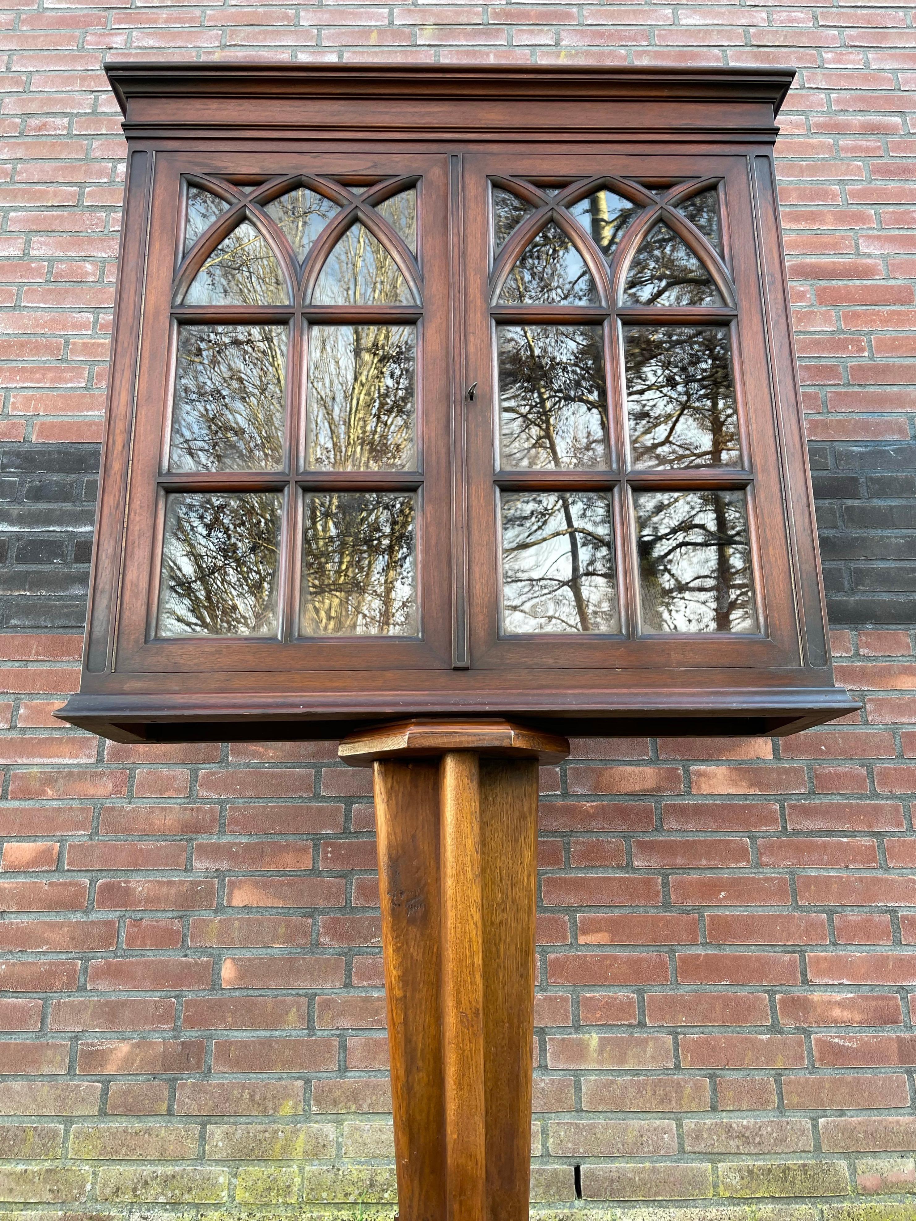 Unique and amazing wall cabinet with church window like doors.

This handcrafted and rare Gothic Revival wall cabinet from the late 1800s is another one of our magnificent recent finds. The size, the quality of the make and the calm Gothic design