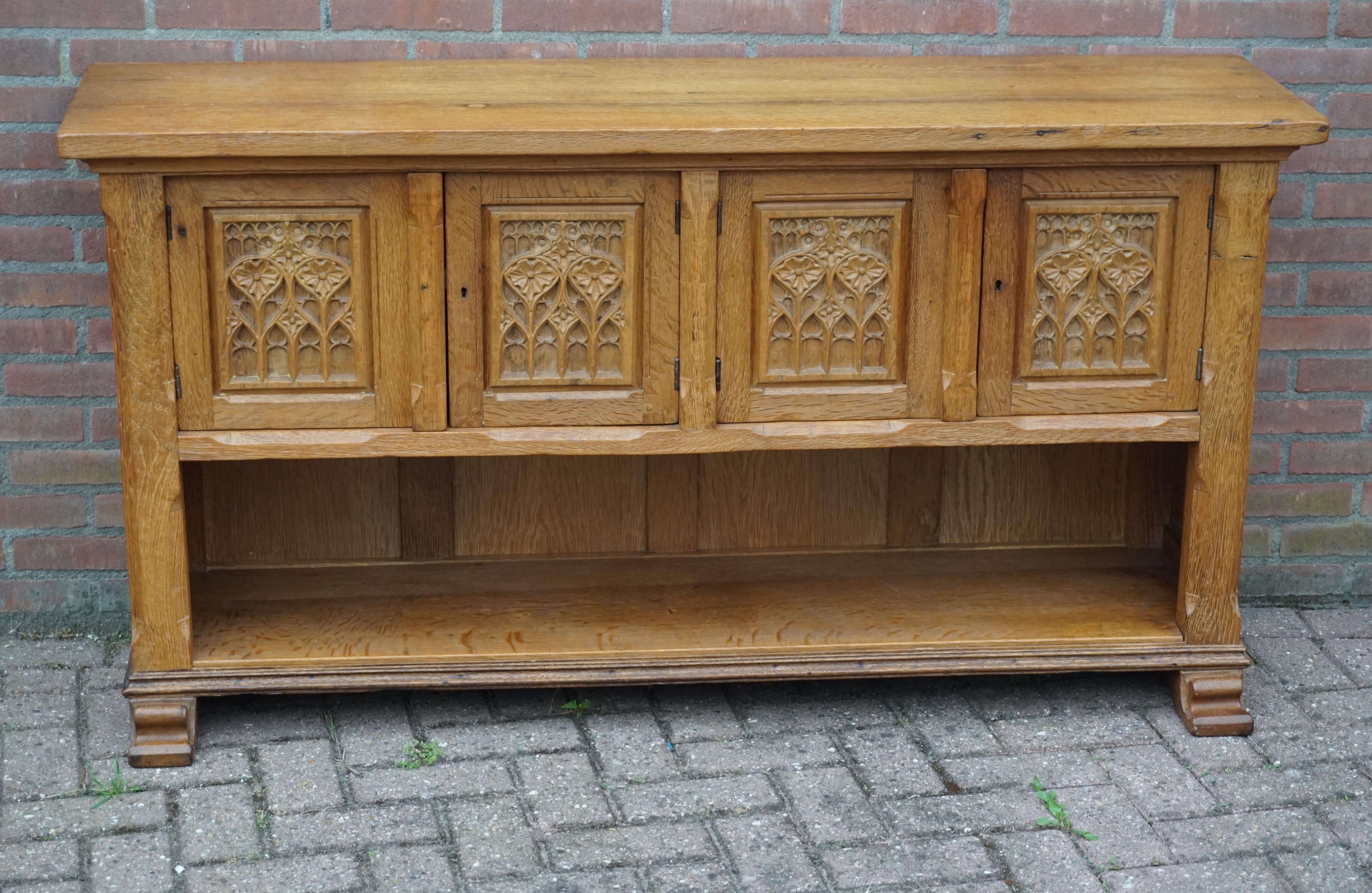 Beautiful and practical, half open design credenza.

This antique Gothic Revival cabinet can be placed tight on your wall and thanks to its wide and undeep design this medieval style beauty can be placed almost anywhere without taking up too much