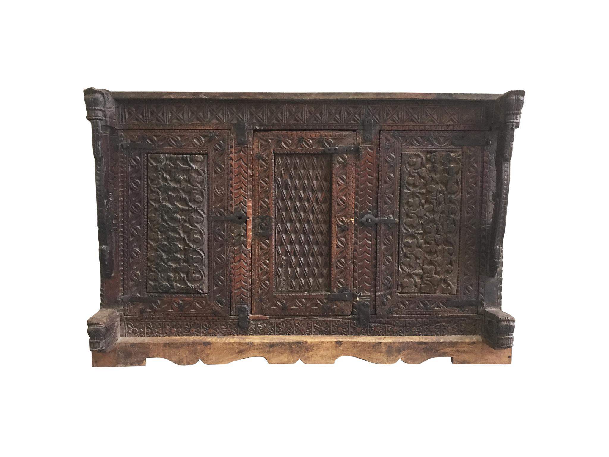 A beautifully aged Gothic Revival cabinet crafted from walnut, circa late 18th-early 19th century. The wood is a warm reddish brown. It has accrued a fine, textured surface that can only be acquired through age. The cabinet's facade is elaborately