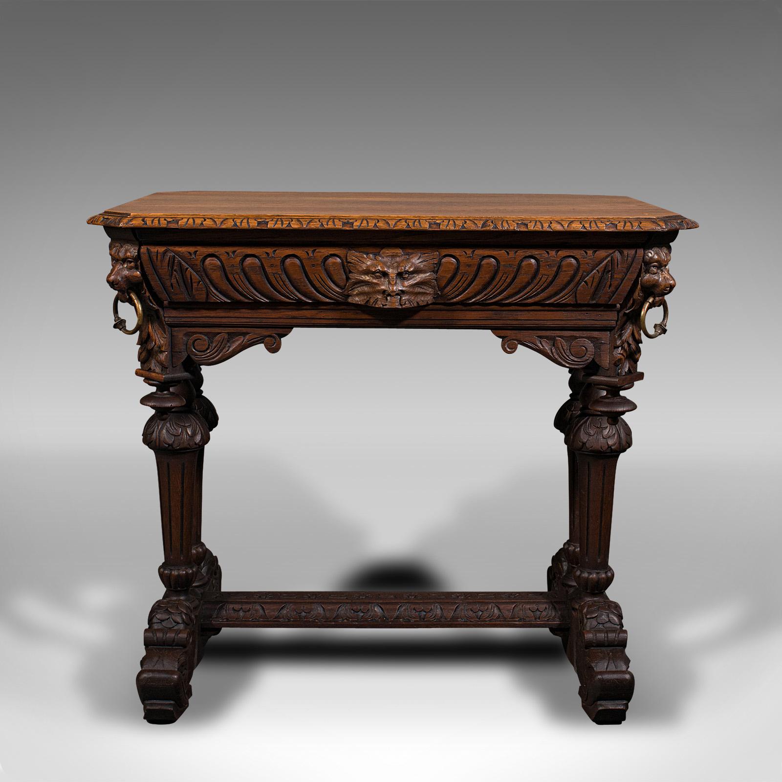 This is an antique carved side table. A Scottish, oak correspondence desk with Gothic revival taste, dating to the Victorian period, circa 1880.

Impressively carved with a cornucopia of detail and themes
Displays a desirable aged patina and in