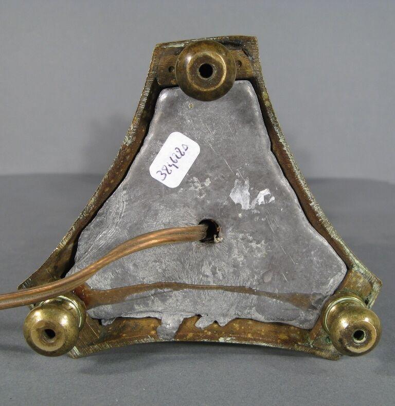 This highly decorative Gothic-style candle holder in gilded bronze dates from the second half of the 19th century. It features rich ornamentation with motifs of three angels, fleur-de-lis, and representations of Christ, the Virgin Mary, and Saint