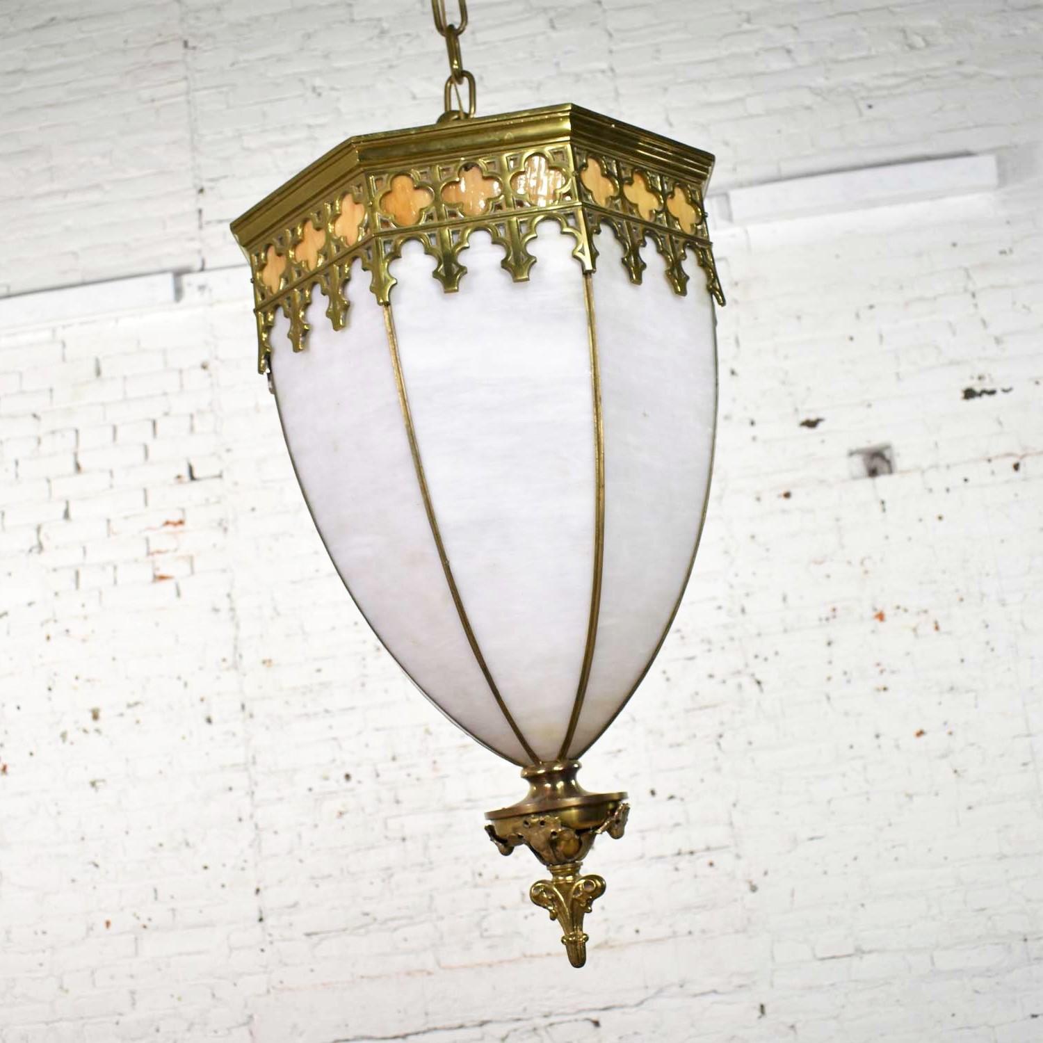 Fabulous antique octagon chandelier pendant light in a Gothic style and comprised of slag glass and brass with the appearance of an inverted polyhedral dome. We have two of these available but have priced them separately. They are both in wonderful