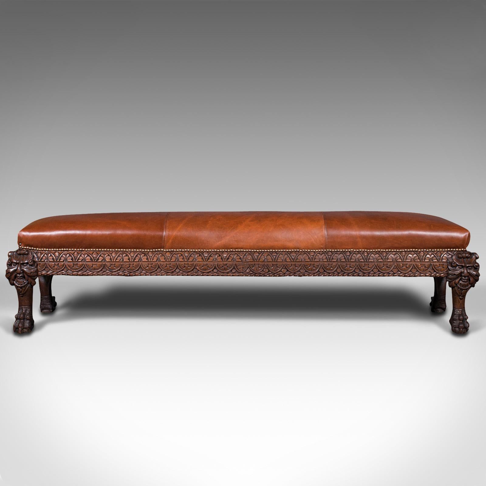 This is an antique carved window seat. An Italian, oak and leather bench or hallway pew, dating to the Victorian period, circa 1880.

Warm and inviting colour palate with a striking carved appearance
Displays a desirable aged patina
