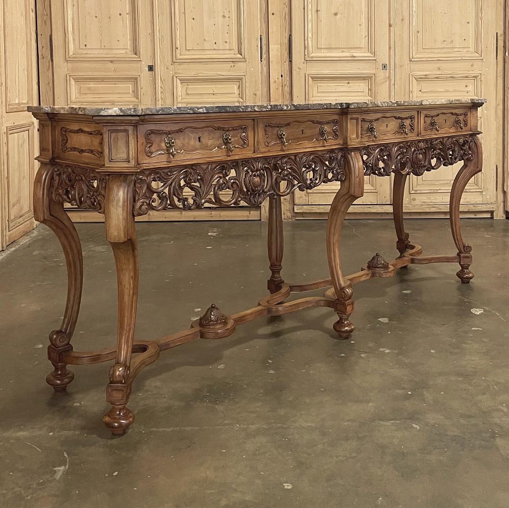 Antique Grand Italian Baroque marble top console or sofa table is a remarkable feat of sculpture, hand-carved from exquisite blonde walnut and left in the natural coloration that has attained a lovely patina. Six legs, five of which are