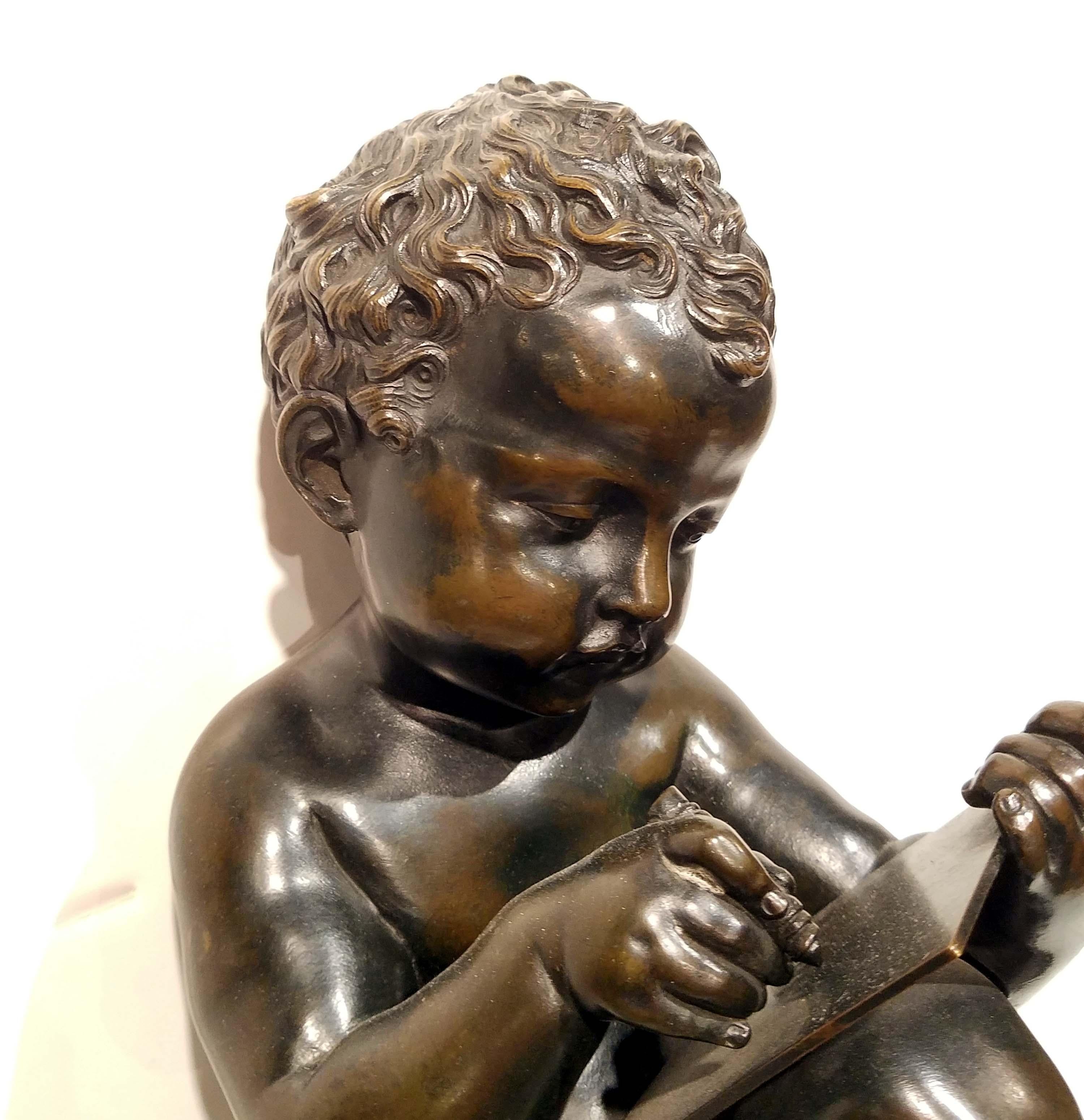 Patinated Antique Grand Tour Bronze of a Cherub Writing on a Tablet