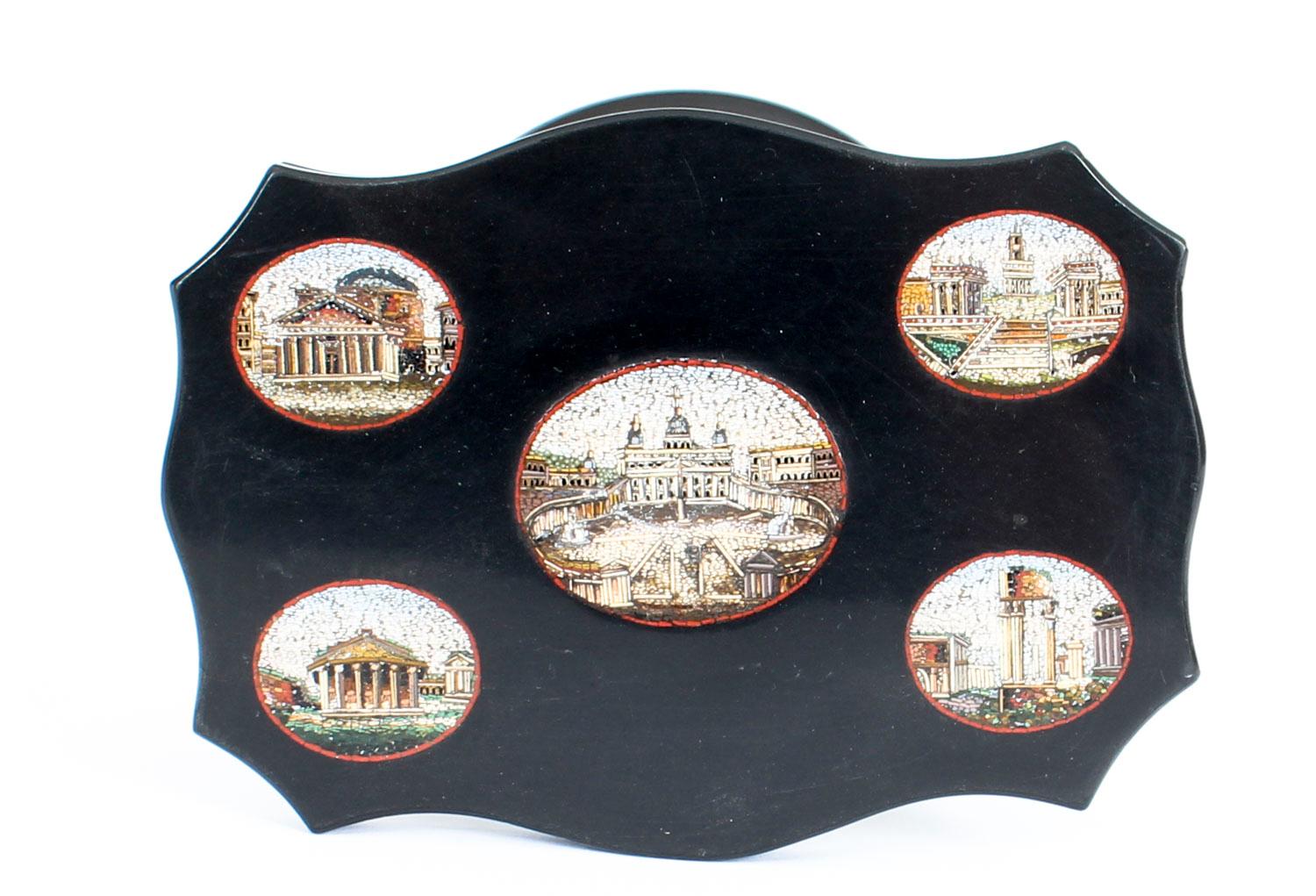 This is a stunning decorative antique Italian Grand Tour Vatican Micro-Mosaic inset black marble desk weight, in the form of a miniature table, circa 1870 in date.

The cartouche shaped table top with a central depiction of Saint Peter's Basilica