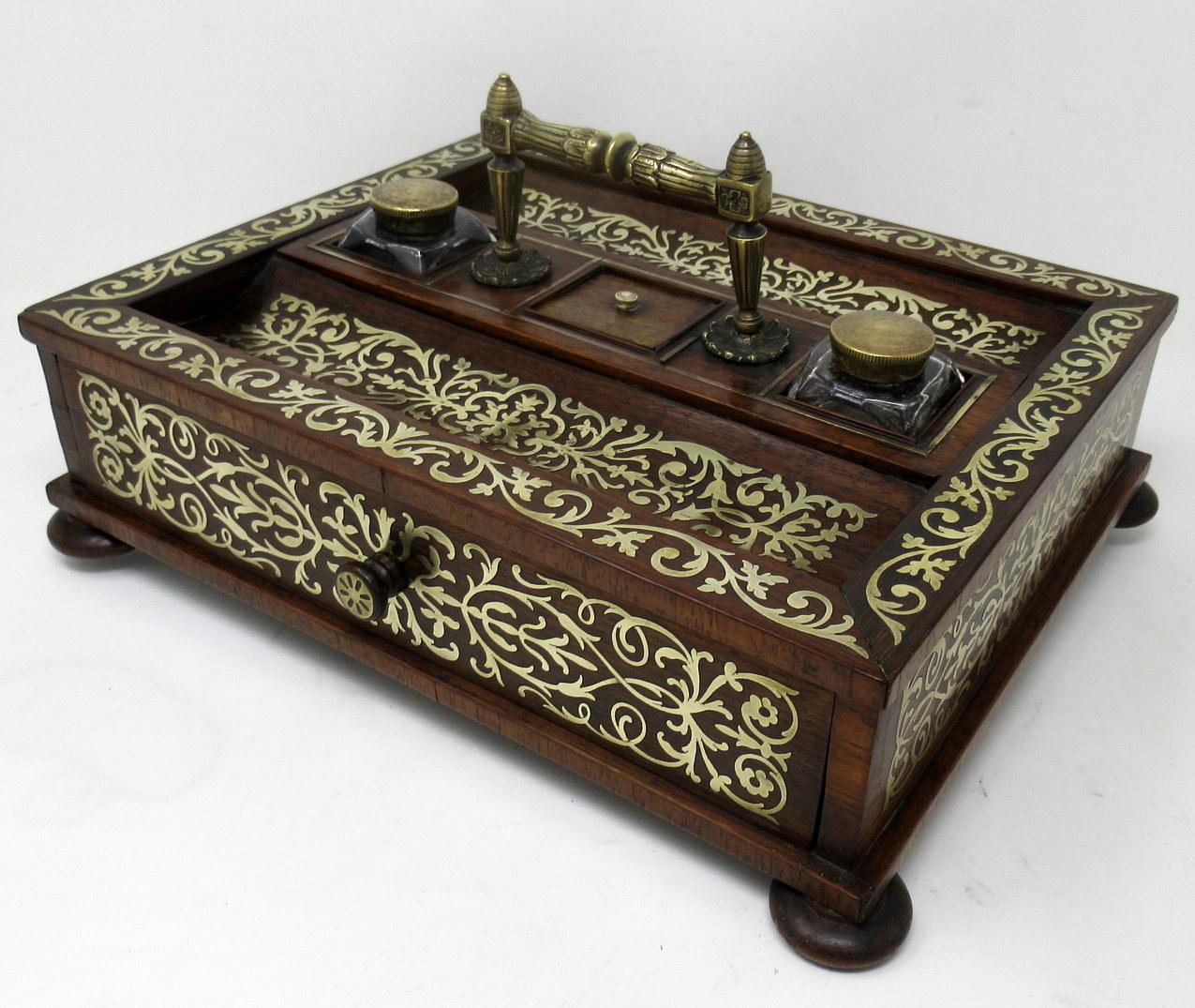 Stunning and Rare Example of an English Grand Tour Regency period brass inlaid Mahogany Inkstand of rectangular outline and generous proportions. First quarter of the Nineteenth Century. 

The entire outer main area with lavish polished brass inlay