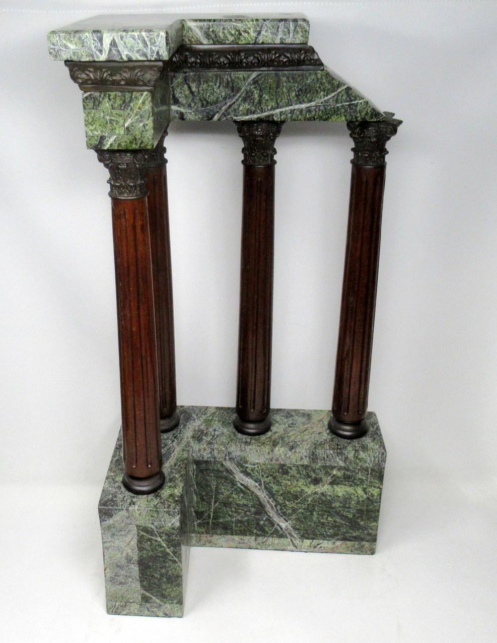 A very impressive example of an Italian Grand Tour inlaid marble and bronze mounted architectural element modeled after a classical early Roman Temple,
last half of the 19th century. 

This rare and unusual corner ruin features four carved wooden