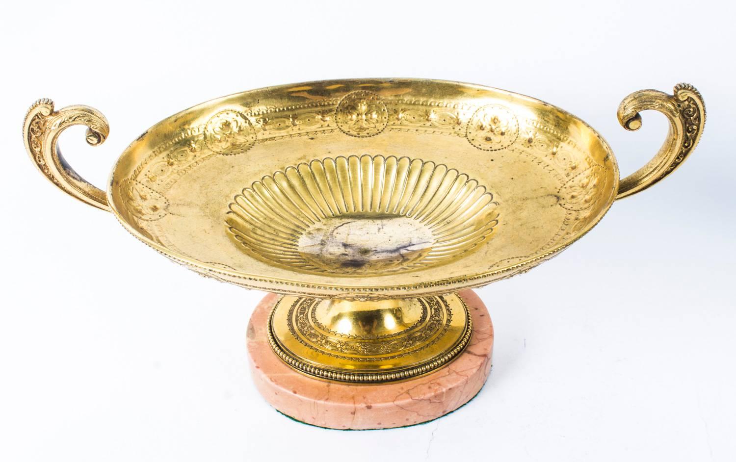 This is an elegant antique Grand Tour French neoclassical ormolu oval two-handled table centrepiece, circa 1870 in date.

This beautiful centrepiece in the form of an Athenian Kylix vase is half-fluted and embossed with paterae, the flying-scroll