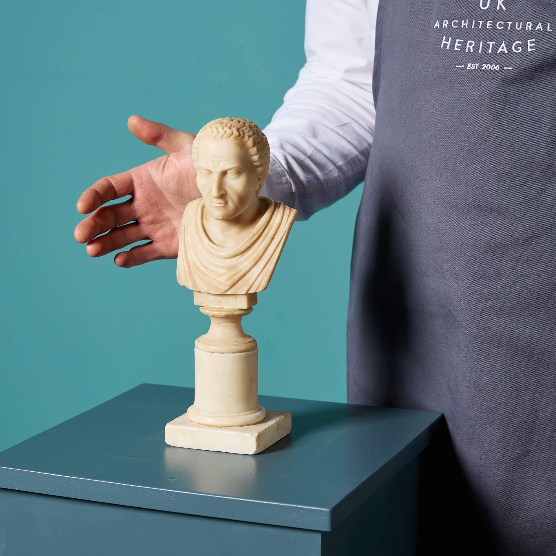 An antique Grand Tour style alabaster bust of a classical Grecian figure.

Dating to the late 19th century, the hand carved figure thought to be Chronos, Greek God of Time, is complimented by a tablet titled 'of times' displayed on cylindrical