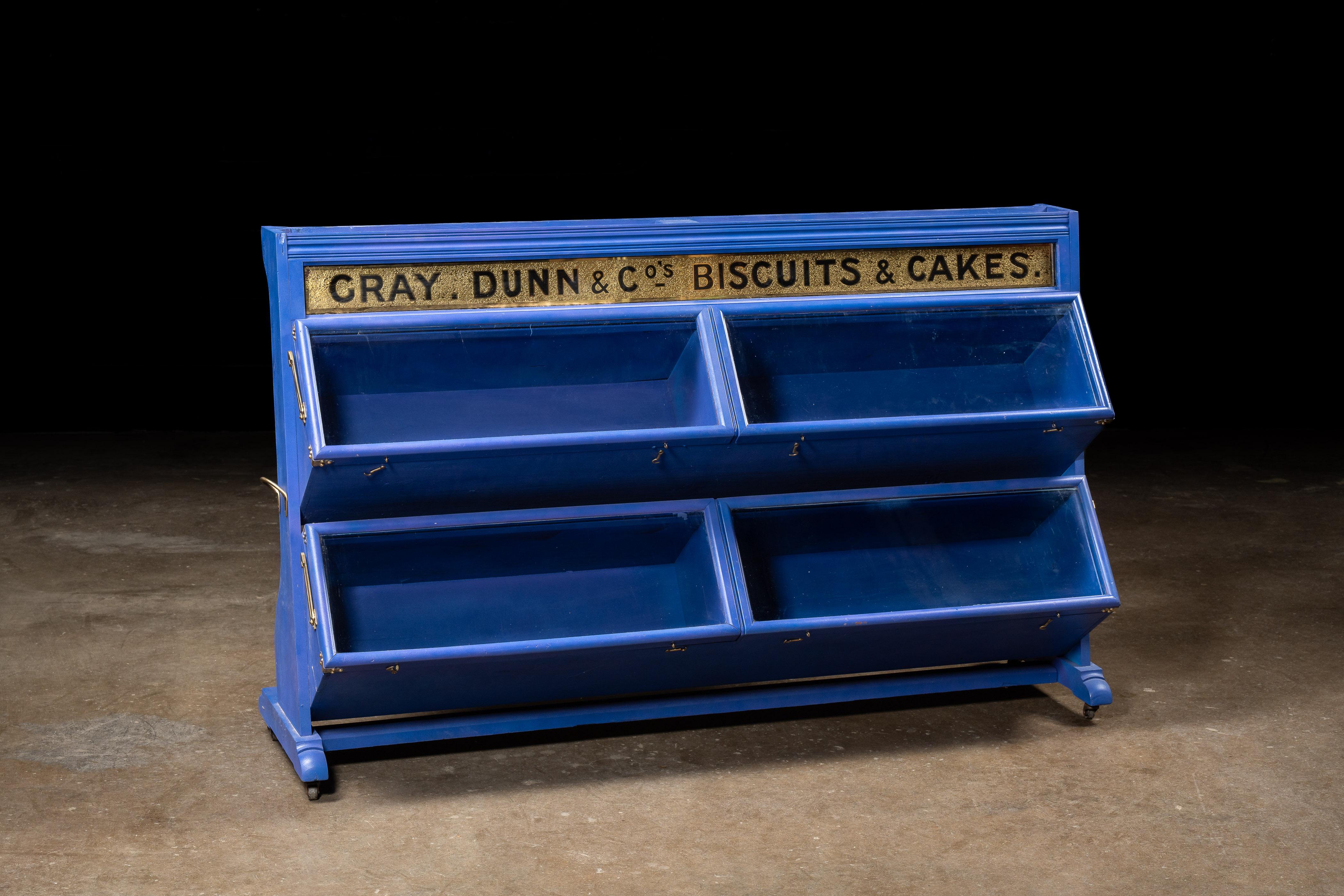 c. 1920s; mfd. by Parnall & Sons for Gray, Dunn & Co. - Glasgow, Scotland

Antique rolling bakery display case with gilt banner sign.

This piece was used to sell baked goods from Gray, Dunn & Co., a Glasgow-based baking company. Gray-Dunn