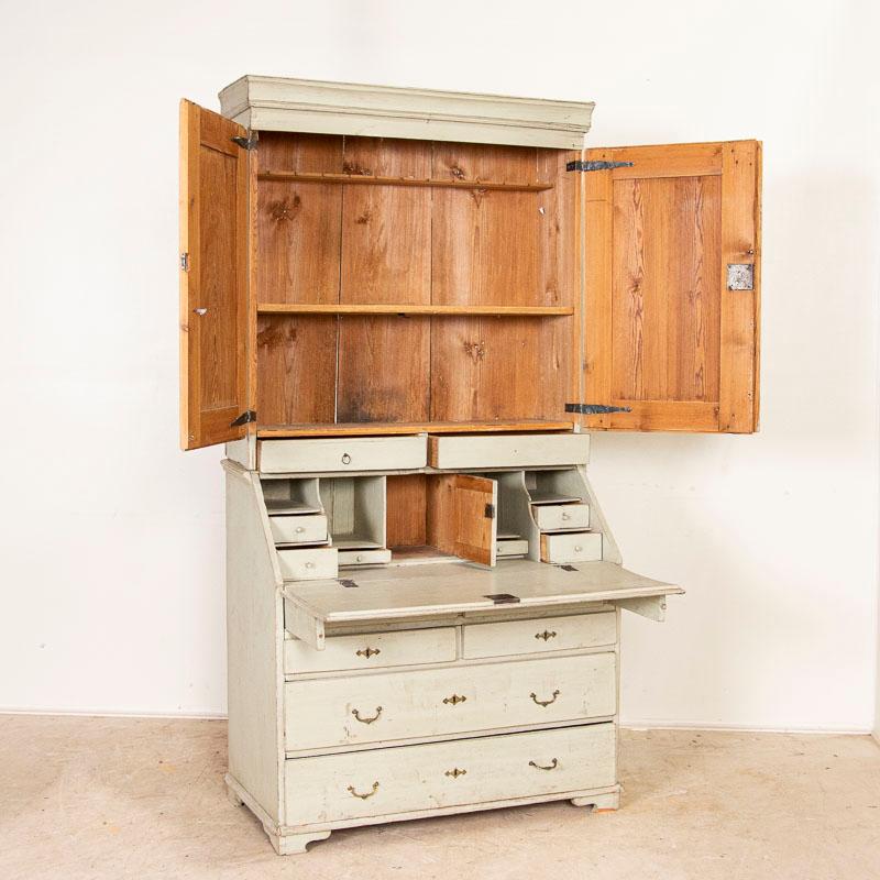 Stately and elegant, this tall dove gray gustavian pine secretary shows off with the distinctive diamond details in the door panels. Also known as a bureau, this secretary would have been a 