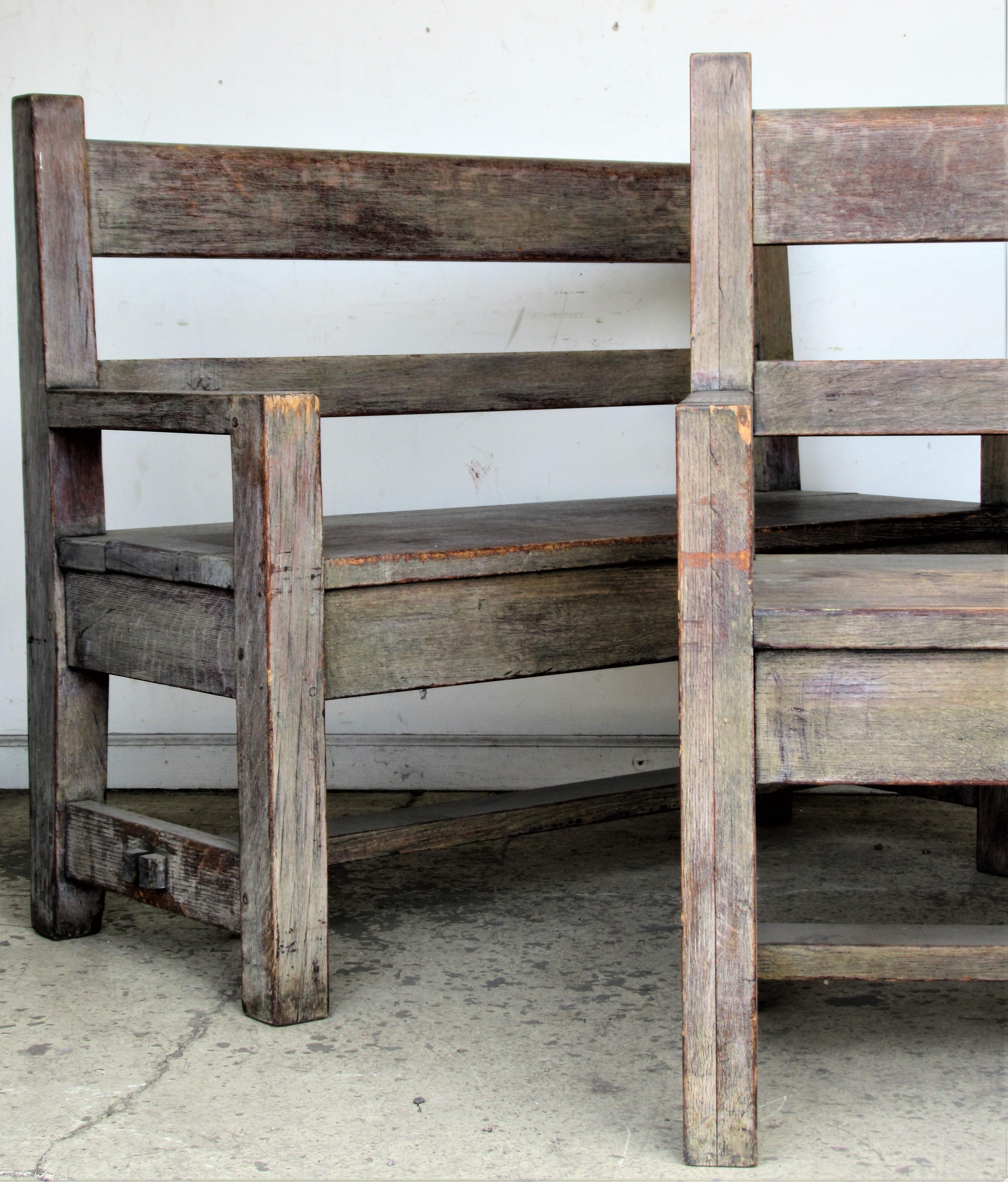 A pair of antique American Arts & Crafts period solid oak benches in beautifully aged old pale gray washed and cerused finish. These two matching benches were reconstructed many years ago from a single long bench (circa 1905-1910) made by the