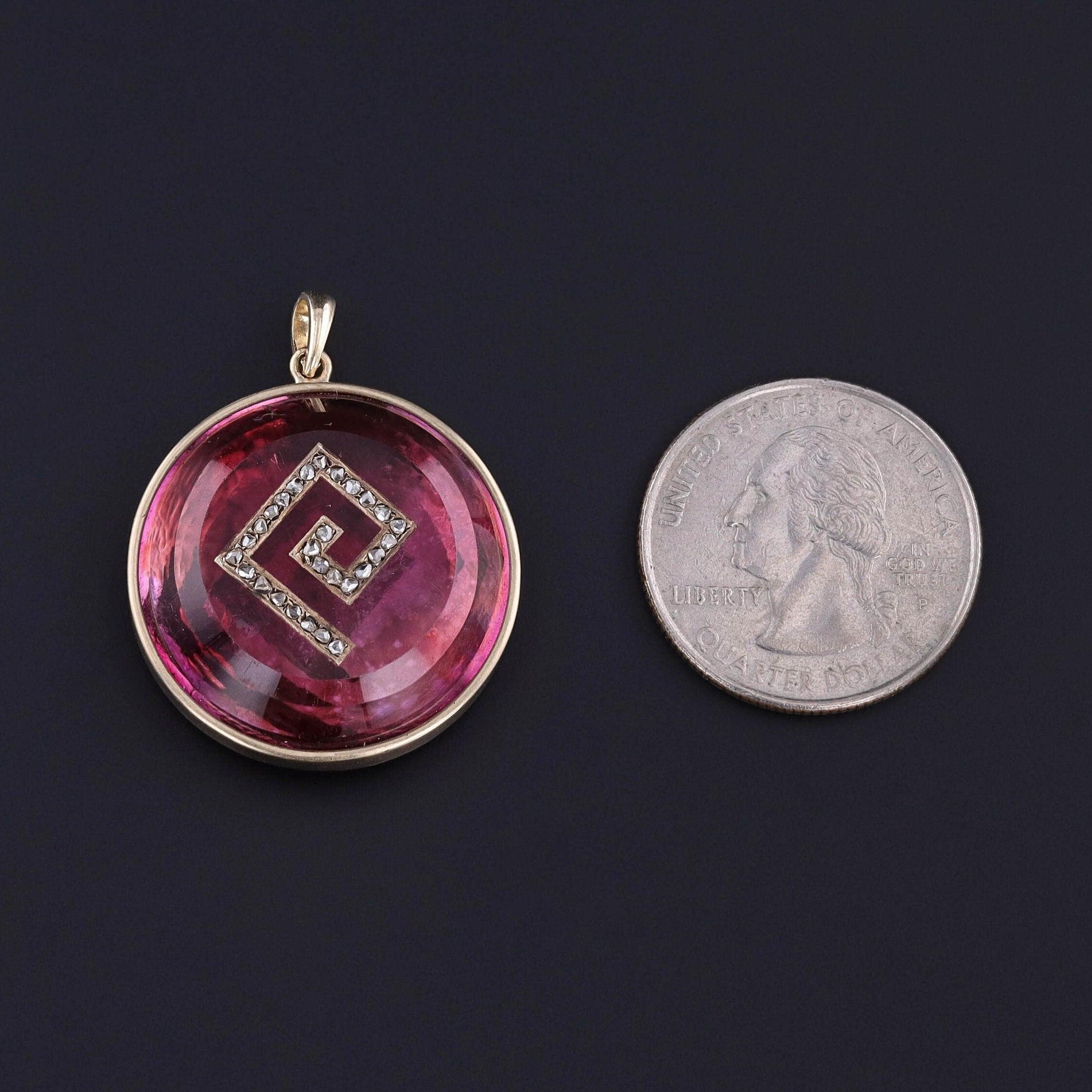 Antique Pink Rock Crystal & Diamond Pendant: Step into the past with this captivating antique 14k gold pendant showcasing a pink foil-backed rock crystal inlaid with a Greek key motif. The Greek key is adorned with rose cut diamonds.

The pendant