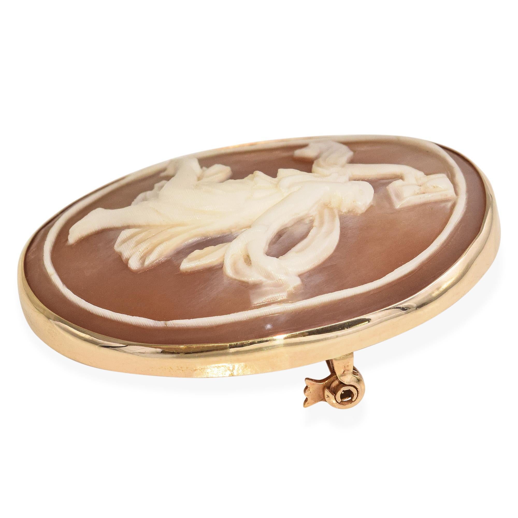 This antique shell cameo pendant features a finely carved Greek muse set in warm 14k yellow gold. The detailed craftsmanship captures the elegance and grace of classical design. Framed in a delicate gold setting, it evokes timeless beauty and
