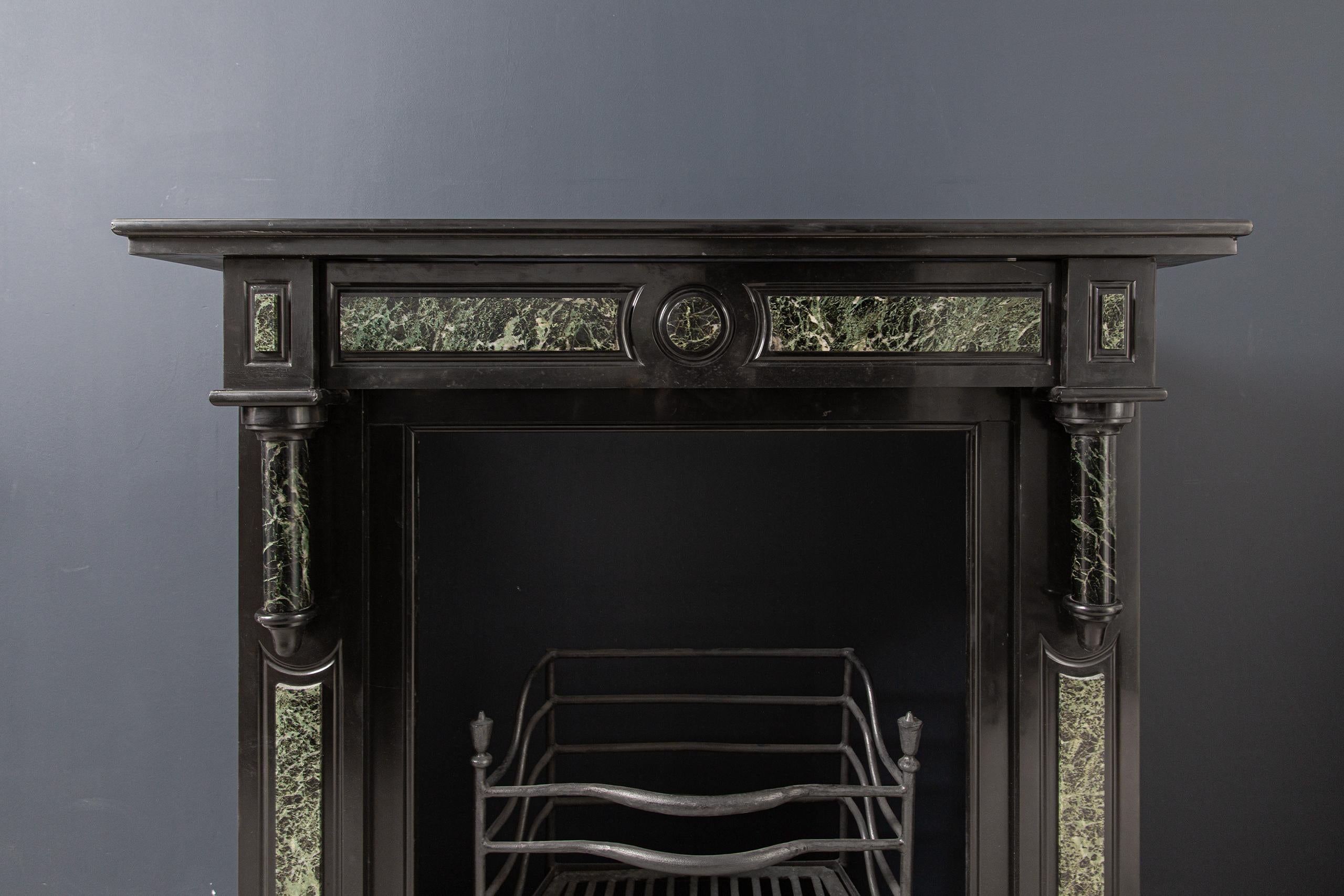 Antique black marble mantelpiece made of Noir de Mazy marble, the black gold. This fireplace is richly decorated with green marble inlays. The consoles are provided with green marble ornaments which hang on the front in front of the consoles. A
