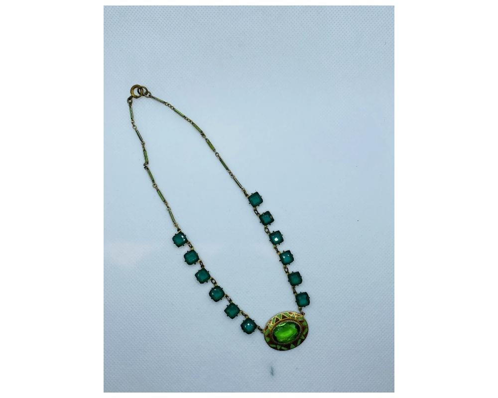 Antique Green and Brown Enamel Green Glass Necklace

Condition some minor wear to the back of the pendant some minor fading to the enamel of the chain please see photos 
size is approximately from end to end 15 inches long the pendent is 1