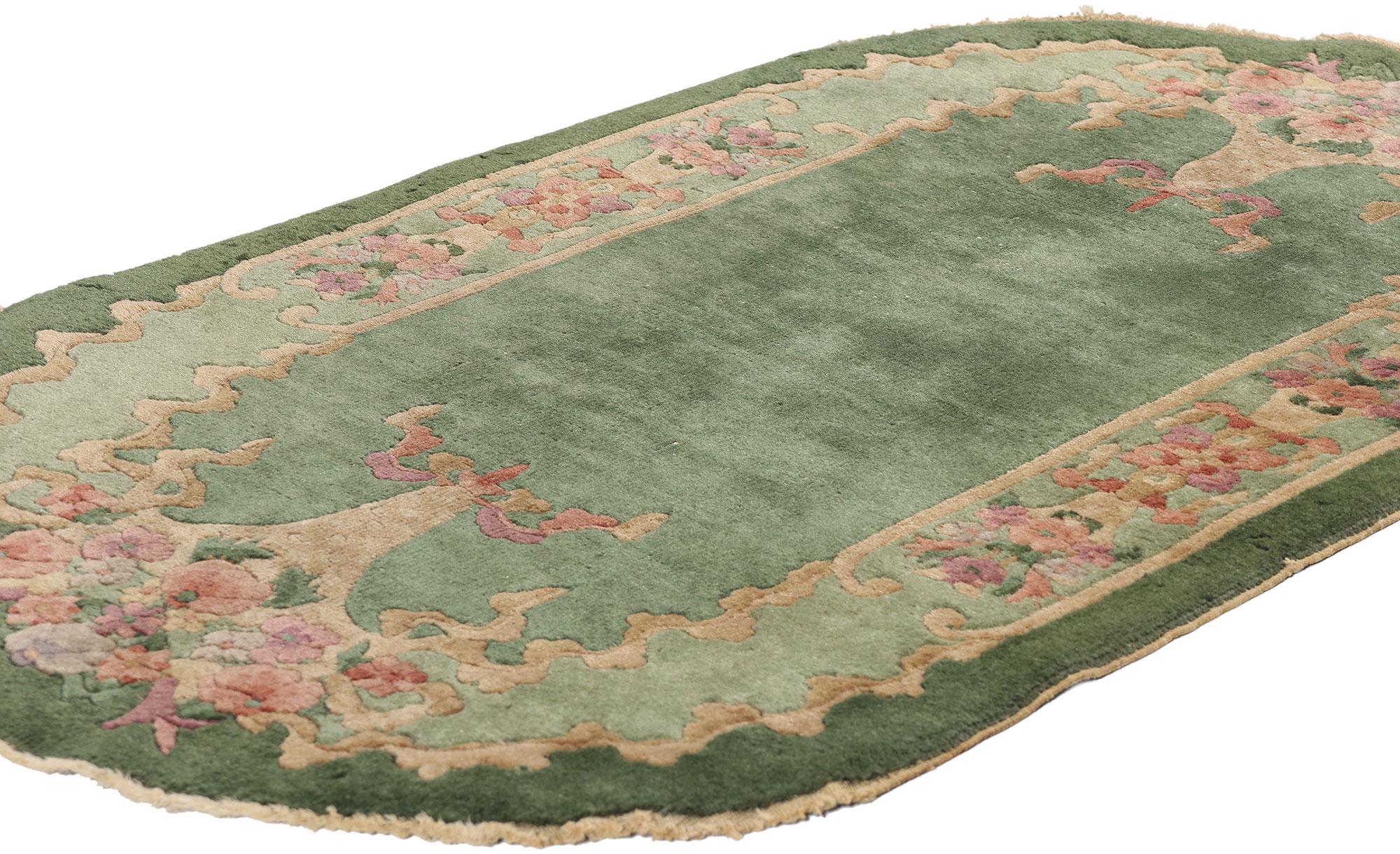 78990 Antique Green Chinese Art Deco Oval Rug, 02'07 x 04'05. This exquisite hand-knotted wool antique Chinese Art Deco rug is a captivating example of the elegance and craftsmanship of early 20th-century Chinese rug-making. Drawing inspiration from