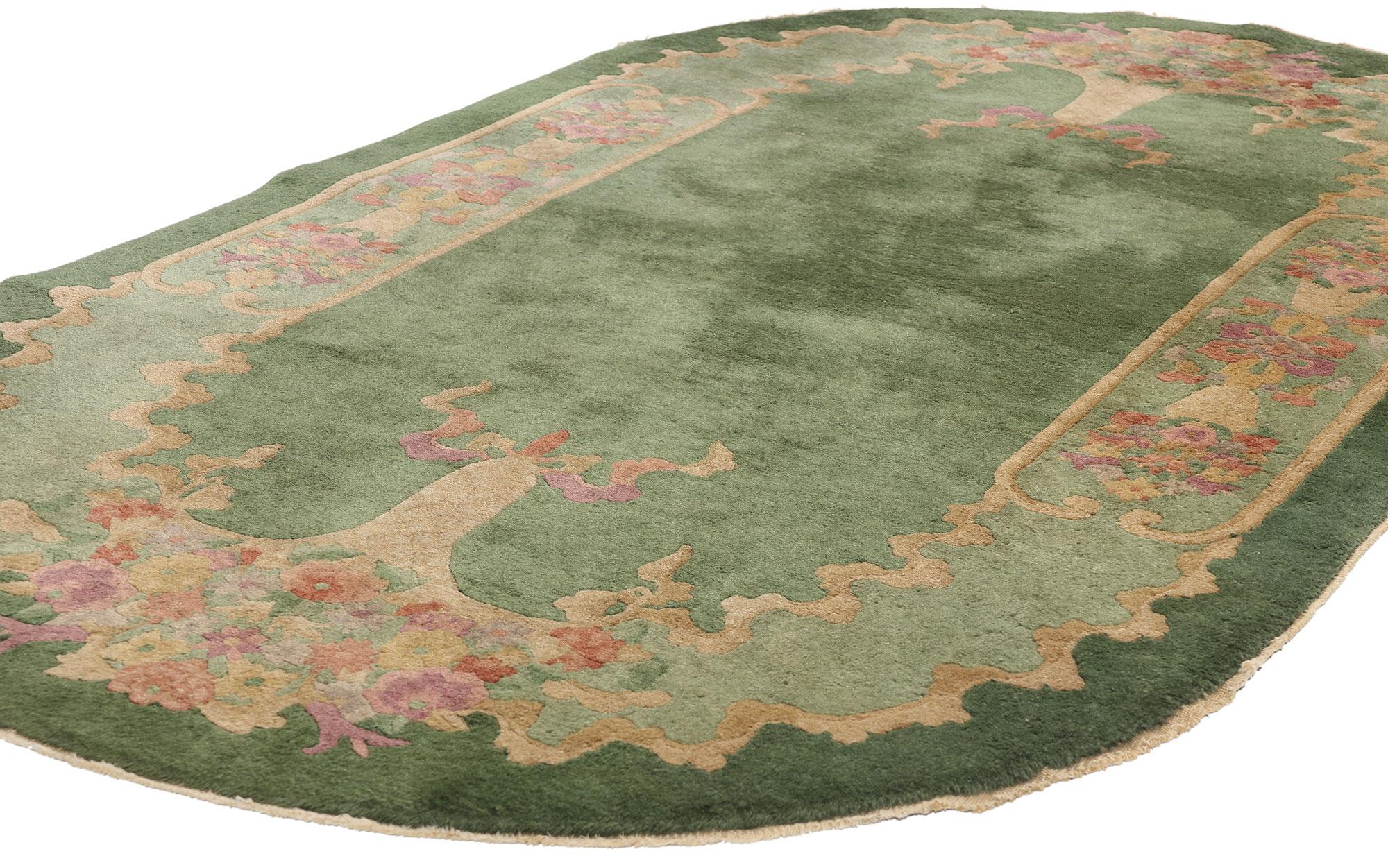 78992 Antique Green Chinese Art Deco Oval Rug, 04'00 x 06'10. This exquisite hand-knotted wool antique Chinese Art Deco rug is a captivating example of the elegance and craftsmanship of early 20th-century Chinese rug-making. Drawing inspiration from