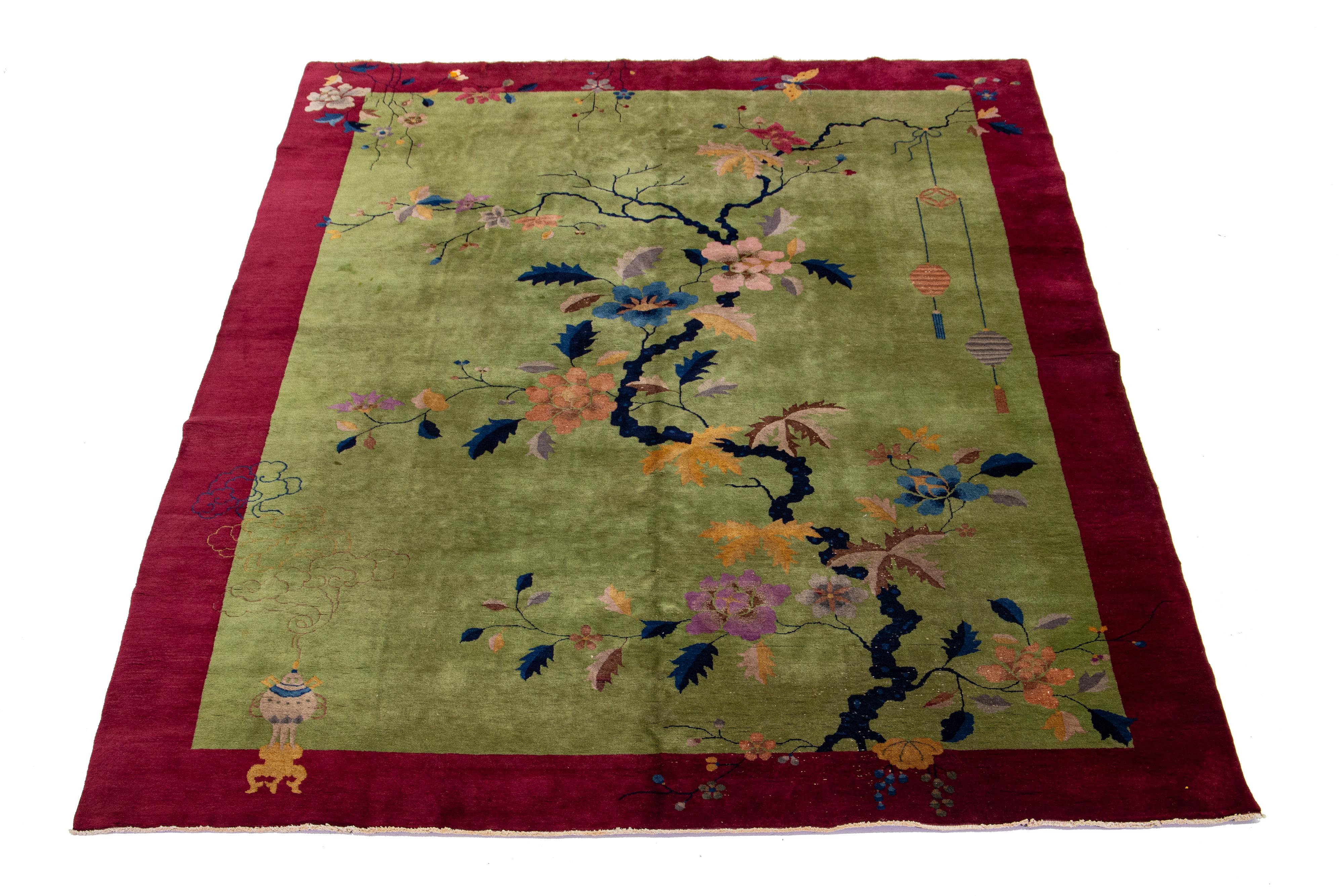 Beautiful 1920s antique Chinese Art Deco hand-knotted wool rug with a green field red frame in a classic Chinese floral nature design.


This rug measures 8' 11