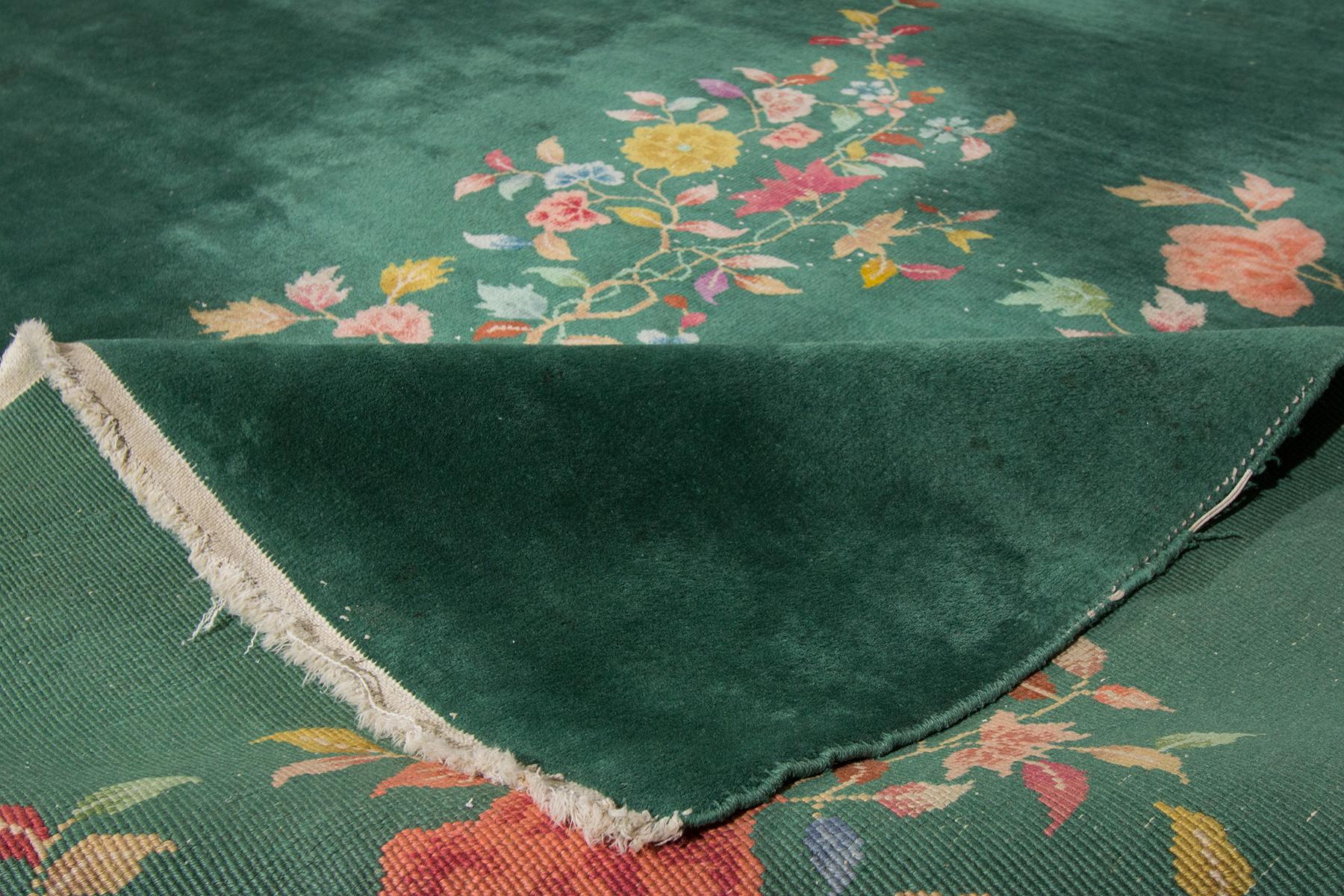 Beautiful antique Chinese Art Deco rug, hand knotted wool with a green field, and multi-color accents in an all-over Classic Chinese floral design,

circa 1920

 This rug measures 8' 11
